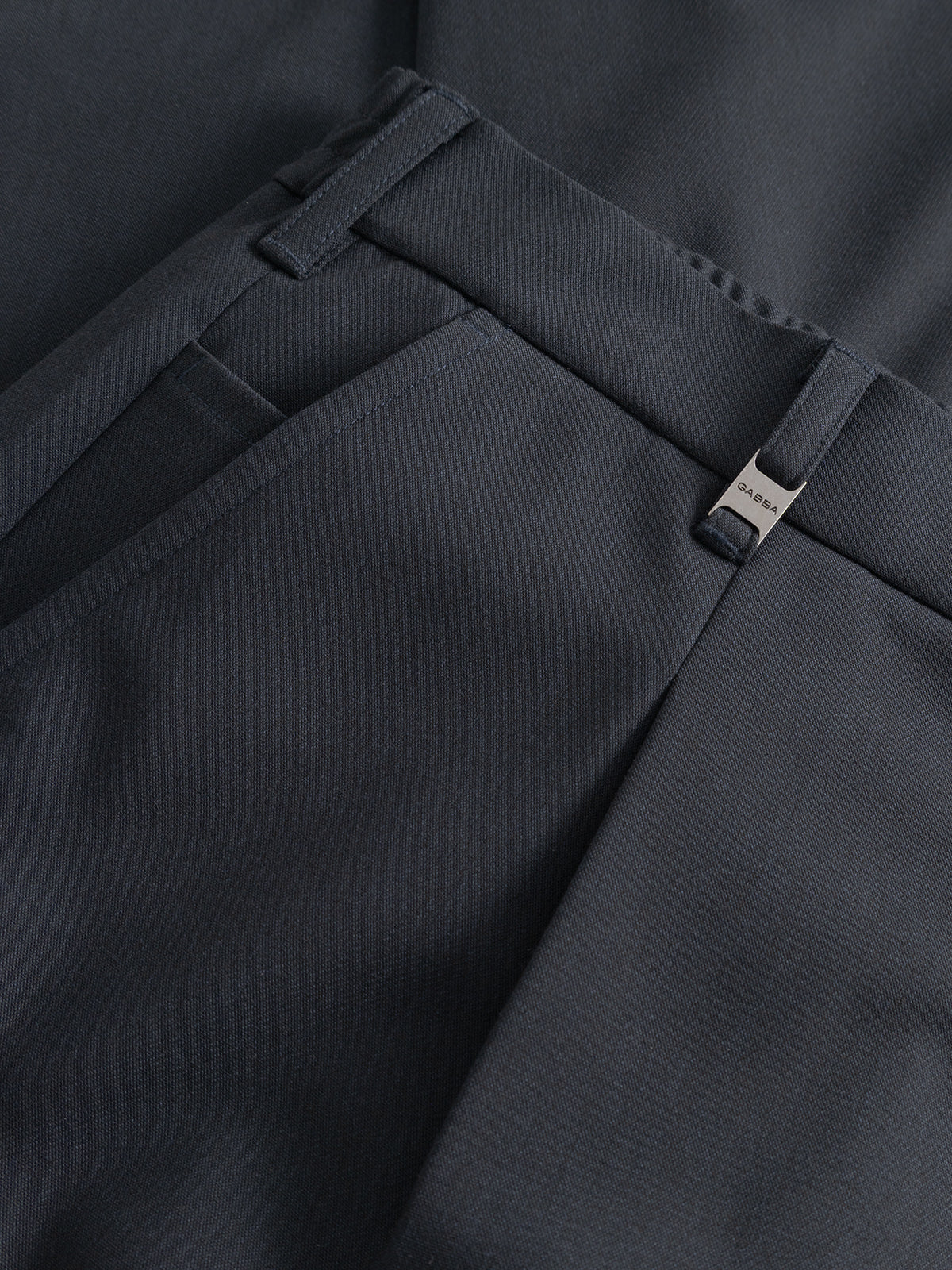 Close-up of Gabba GABnapoli 19 Phin GRS - Blue Black wool blend chino pants, featuring belt loops, a front pocket, a small metallic tag near the waistband, and a smooth, neatly tailored regular straight fit.