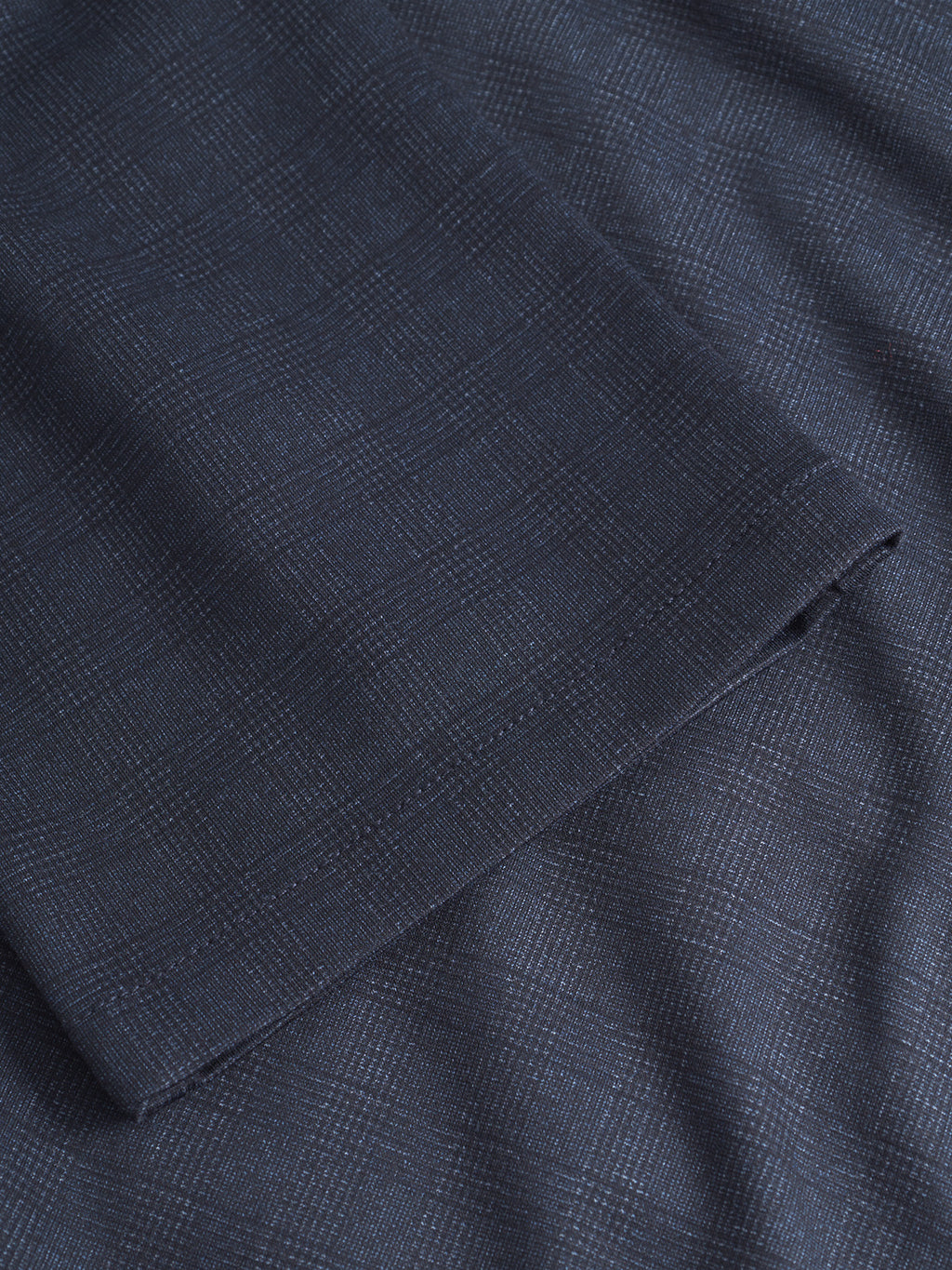 Close-up of the GABpaul Nygo - Navy by Gabba, featuring dark blue fabric with a subtle plaid pattern, comfort stretch material, and a neatly folded edge—ideal for a versatile chino style.
