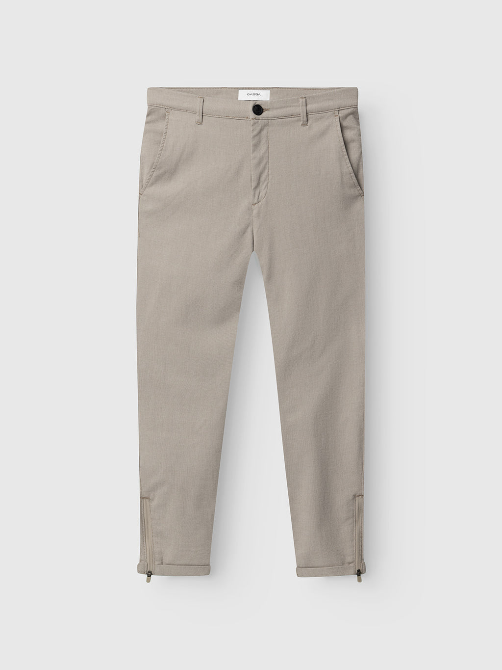 The Gabba Pisa Domo Pants in Coriander feature a slim fit, button and zip closure, side pockets, and ankle zippers. Shown flat on a white background, they’re a stylish addition to your everyday wardrobe.