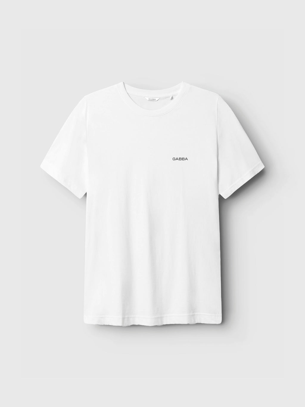 The Gabba GABdune Logo GOTS SS T-Shirt in white features a classic fit, small black Gabba logo on the left chest, and is crafted from GOTS-certified organic cotton. Shown here against a light gray background.