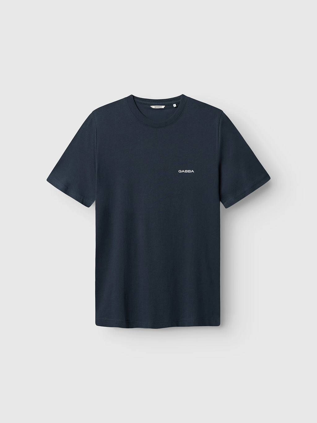 The Gabba GABdune Logo GOTS SS T-Shirt in Total Eclipse features a classic fit, short sleeves, and a small white “GABBA” logo on the left chest, shown against a light gray background.