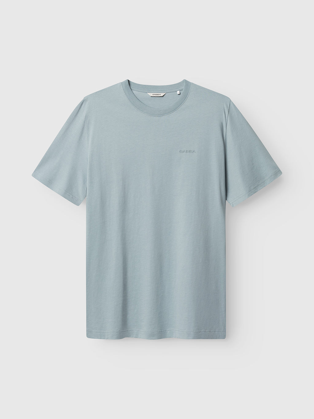 The Gabba GABdune Logo GOTS SS T-Shirt in light blue features a classic fit, short sleeves, and crew neckline, made from GOTS-certified organic cotton with minimal chest branding, shown on a white background.