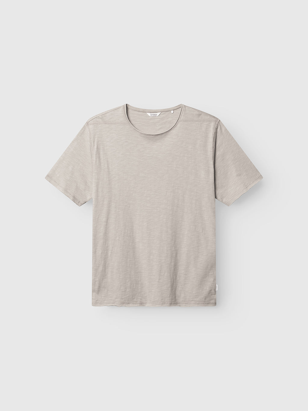 The Gabba GABkostant New SS in Grey Paloma is a short-sleeved, crew neck t-shirt with a minimalist design, crafted from 100% cotton slub fabric and shown laid flat on a white background.
