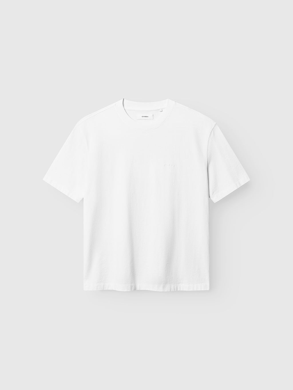 The Gabba GABnigel Wix Boxy Hour SS T-shirt in white is shown against a light gray background, featuring a heavyweight cotton build and a classic, logo-free short-sleeve crew neck design.
