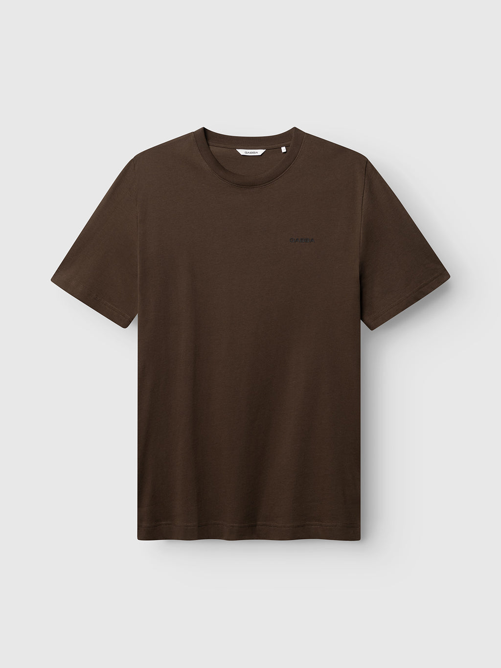 The Gabba GABdune Logo GOTS SS T-Shirt in Brown Slate is a classic fit, short-sleeved T-shirt featuring a small, subtle logo on the left chest, shown against a light gray background.