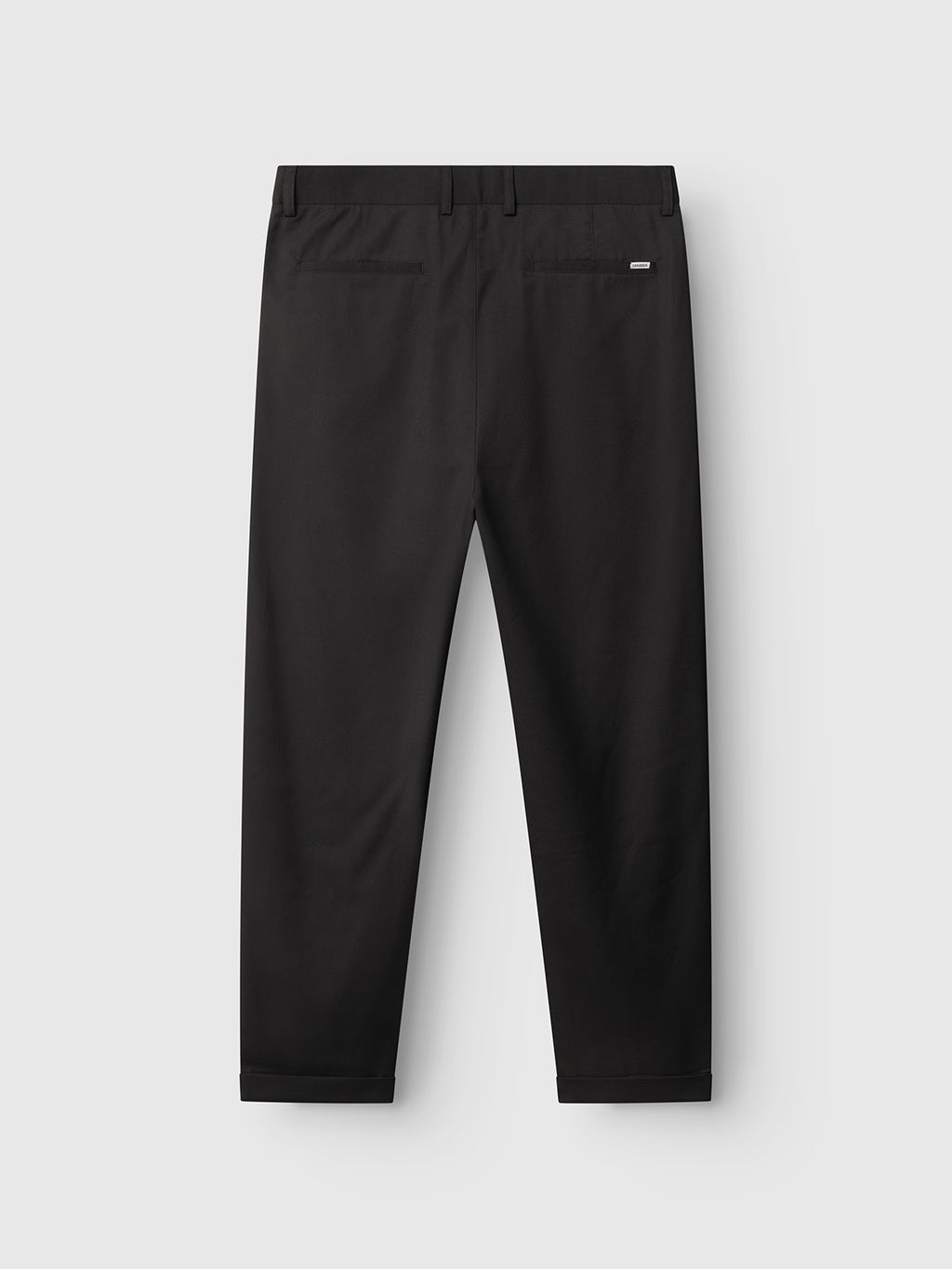 The GABjoe Turnup Fin Pant - Black by Gabba is a straight-leg chino in twill viscose blend, shown from the back with belt loops, two back welt pockets, and a small rectangular label above one pocket.