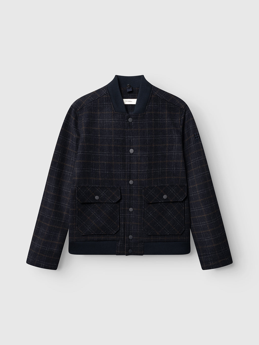 The GABmatheo Check Bomber Jacket by Gabba features a blue check wool-blend design with two large front flap pockets, snap button closures, and ribbed collar, cuffs, and hem. Shown against a plain light gray background, this standout piece showcases contemporary style in men’s outerwear.
