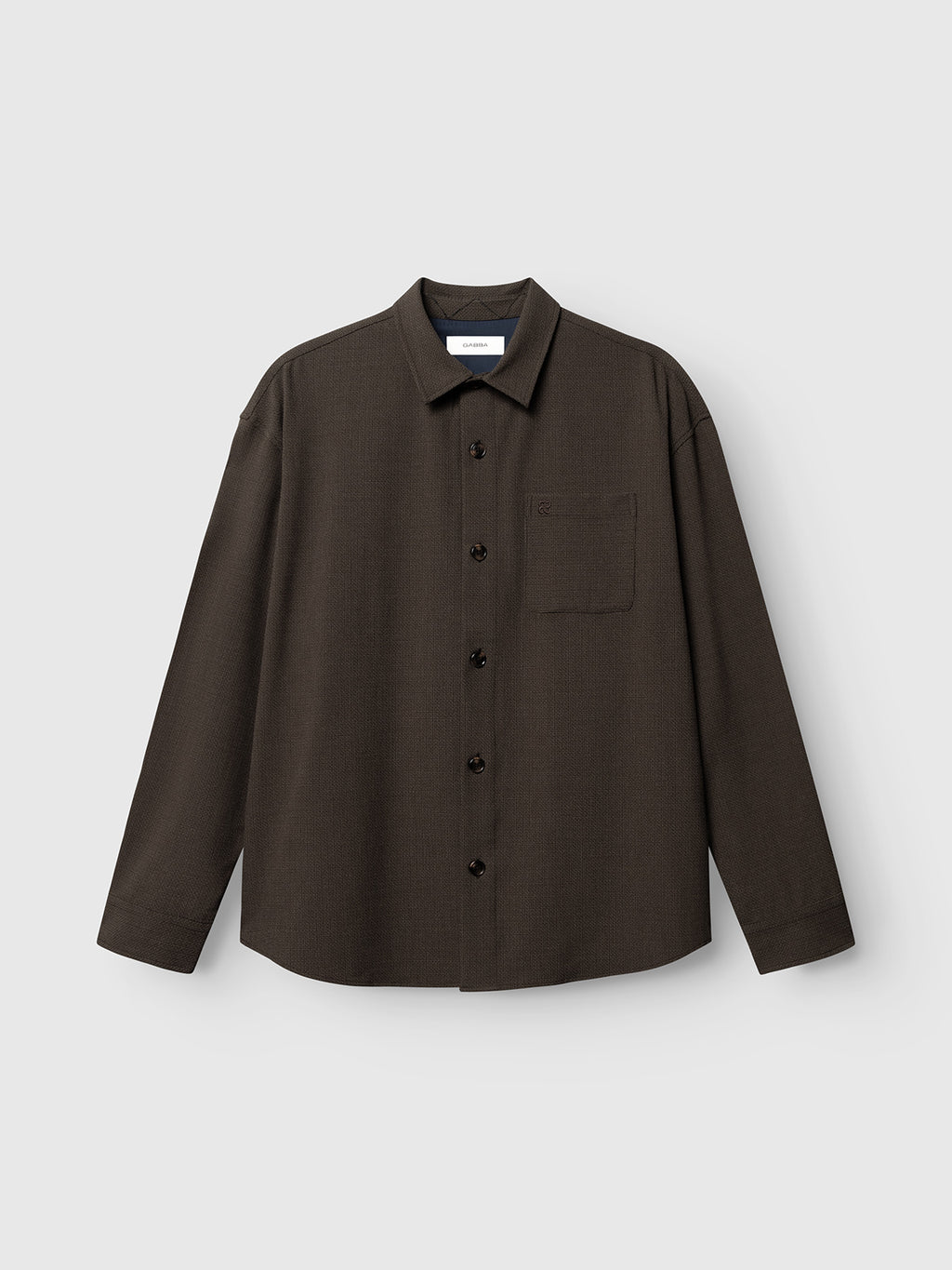 The Gabba GABjens Over Rubin LS Overshirt in Brown Slate is a dark brown, long-sleeved button-up shirt featuring a collar and a single chest pocket, crafted from stretch dobby fabric and shown against a light gray background.