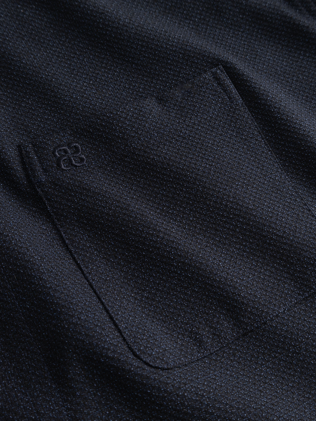 Close-up of the Gabba GABjens Over Rubin LS Overshirt in Blue Black, featuring dark blue stretch dobby fabric with a pocket and a small embroidered logo above it, highlighting the overshirt’s distinctive textured design.
