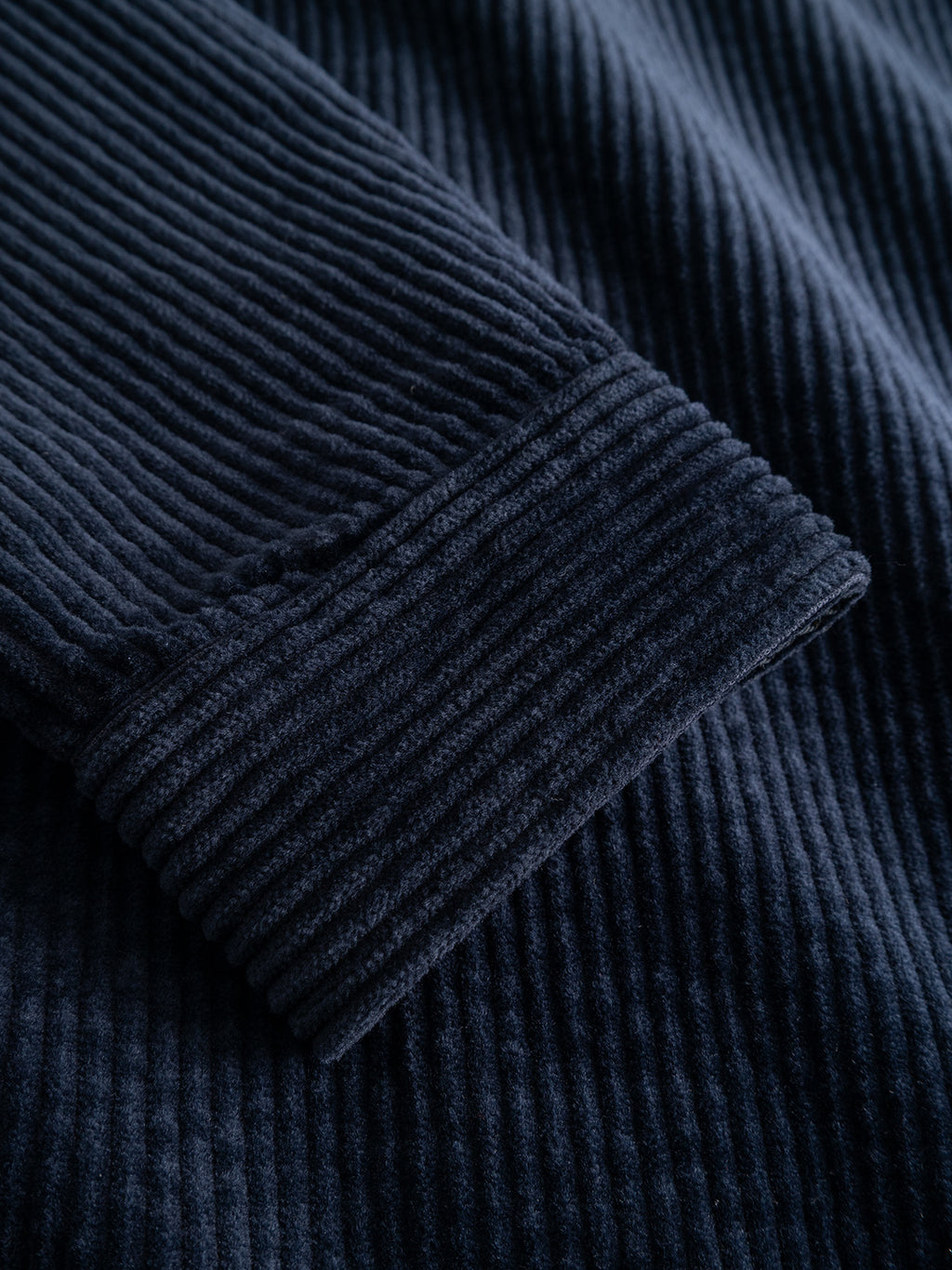 Close-up of the Gabba GABbeta Ibre LS Overshirt in Dark Navy, featuring stretch corduroy fabric with visible ridges and a folded sleeve cuff that highlights the texture and pattern of the material.