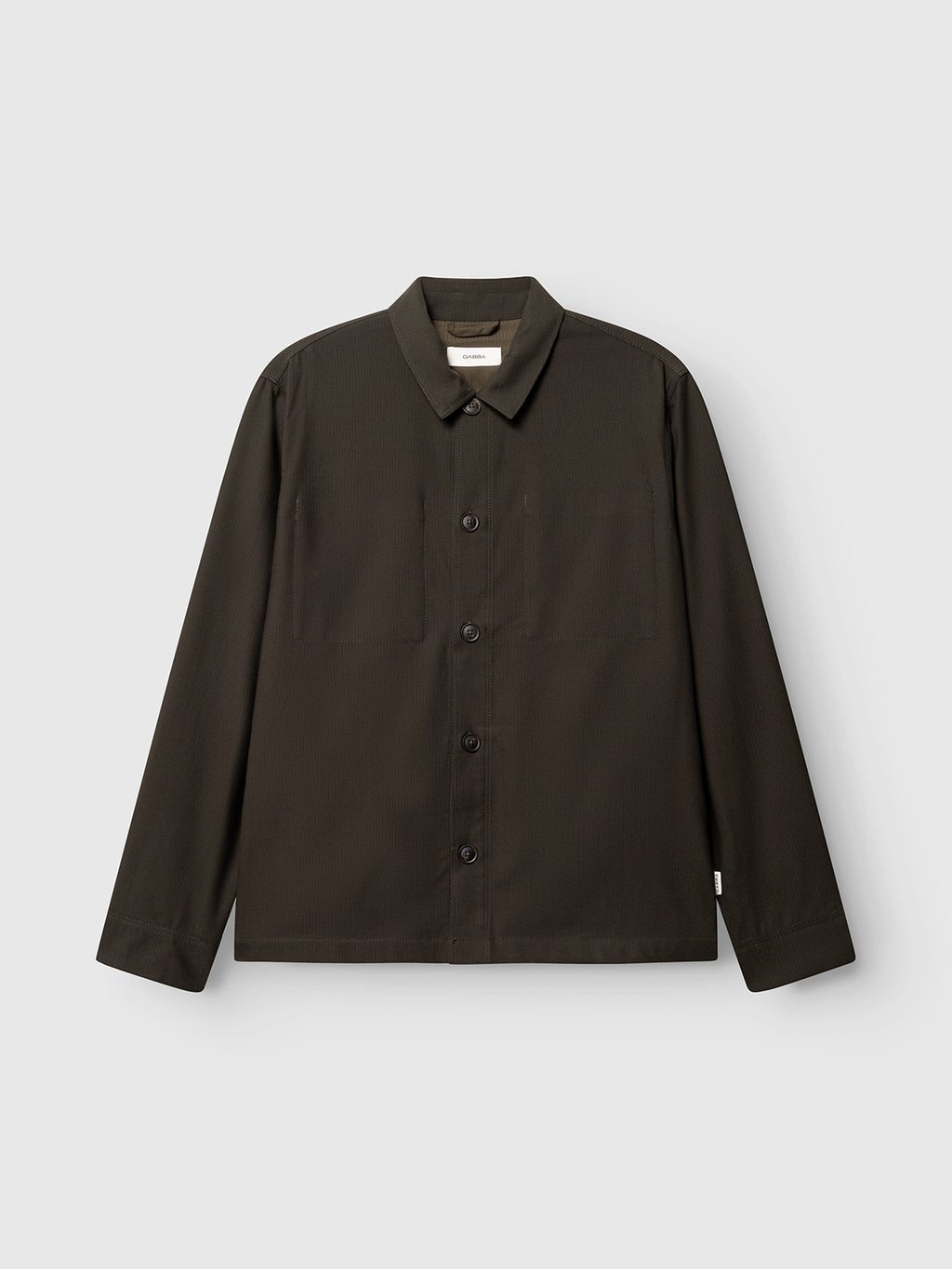 The Gabba GABtogger Base Deme LS Overshirt in Forest Night is a regular-fit, long-sleeve button-up crafted from micro-pattern woven fabric, featuring a collar, chest pocket, and minimalist design, displayed on a plain light gray background.