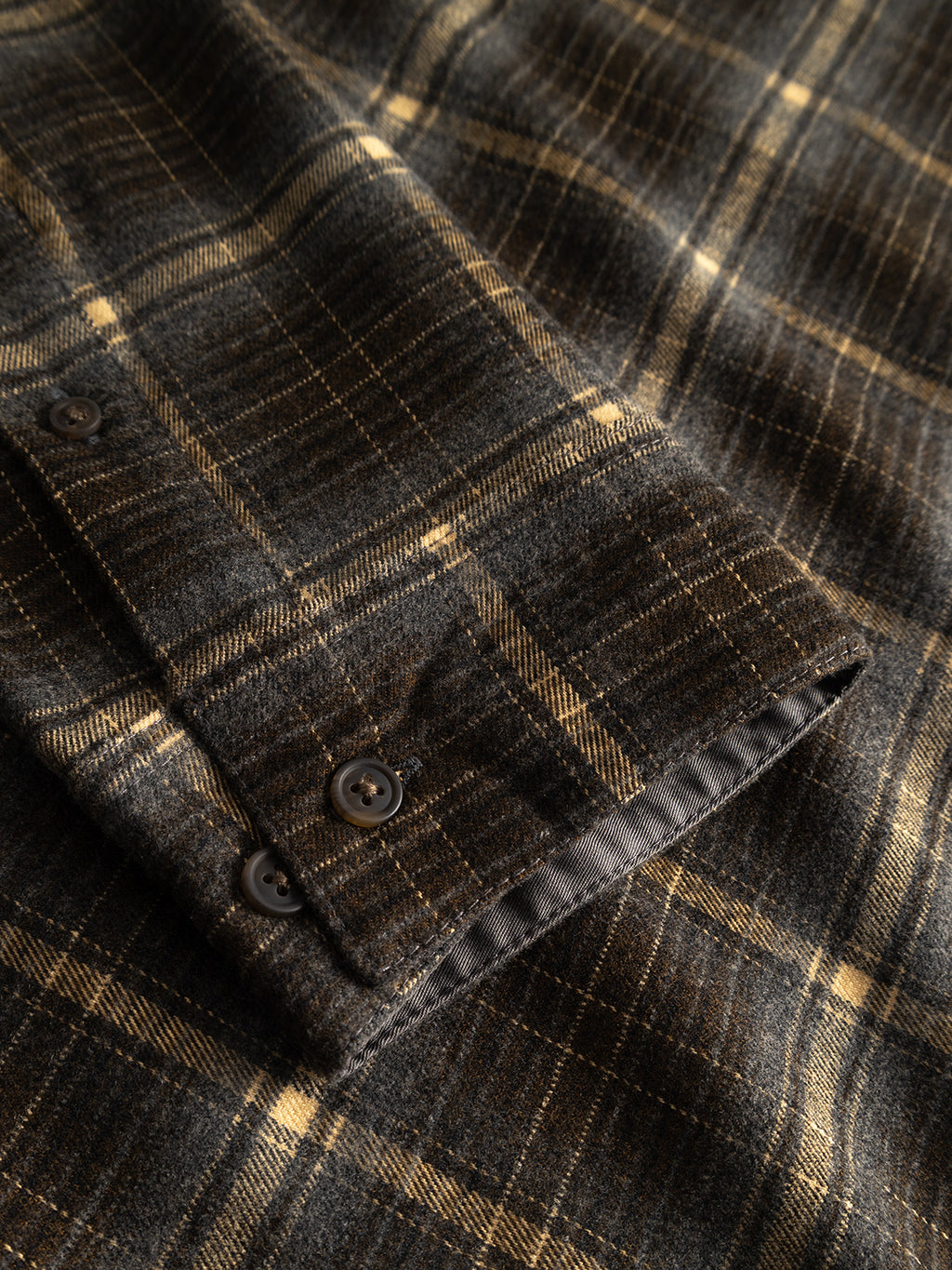 Close-up of the Gabba GABsven Reg F1097 LS Shirt in Forest Night, showing a brown and beige checked flannel sleeve with two dark buttons and detailed stitching.