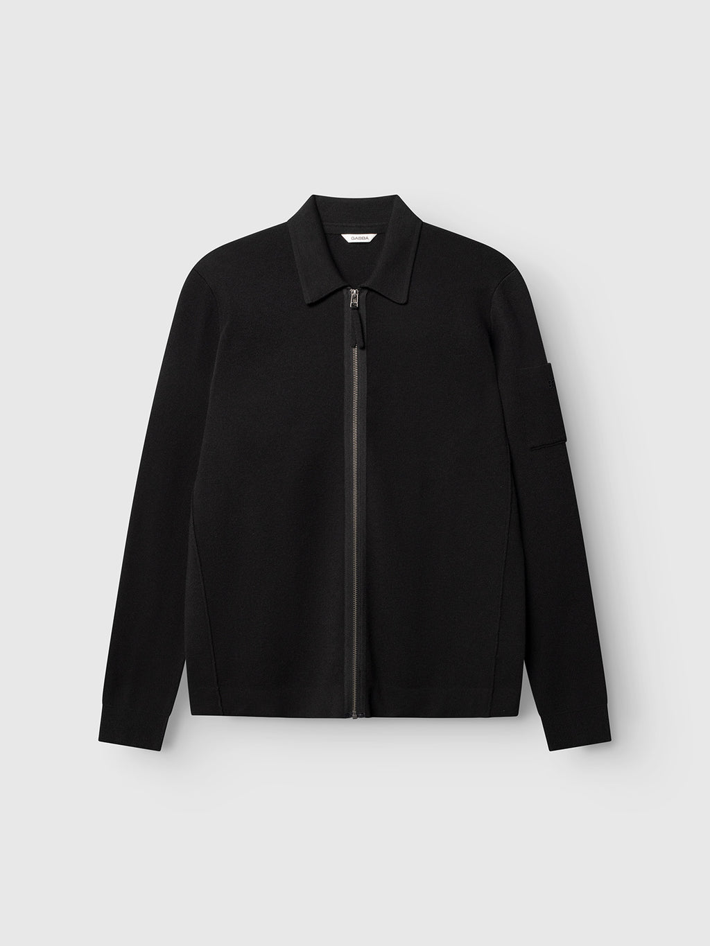 Gabba’s GABadriel Zip Lume LS Knit - Meteorite is a black, long-sleeve, regular-fit knit zip-up jacket with a collar, shown against a plain light gray background. Featuring a minimalist design made from a soft viscose blend, it includes a left sleeve pocket and a full front zip closure.