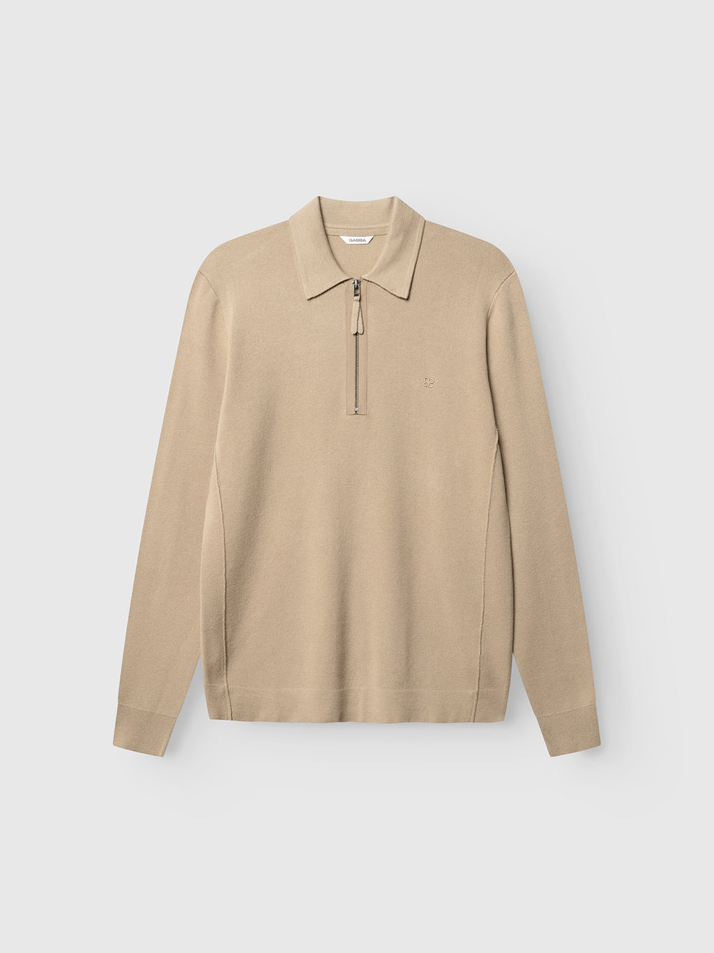 The Gabba GABadriel Half Zip Lume LS Knit - Sand Crocker is a long-sleeve, regular fit knit polo shirt in a beige hue, crafted from a soft viscose blend. It features a classic collar, a short zipper at the neckline, and subtle stitching details, presented against a plain white background.