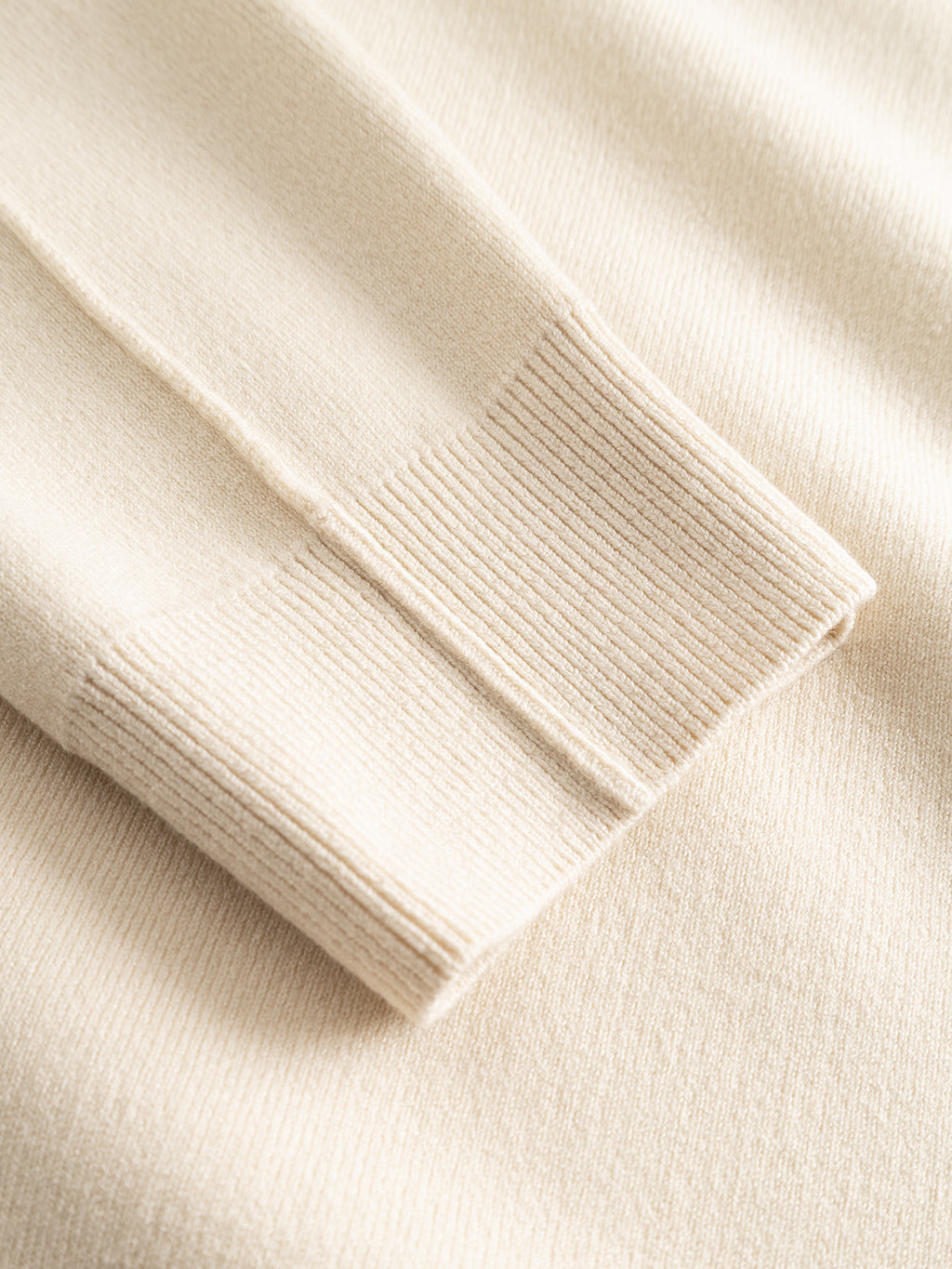 Close-up of the Gabba GABadriel O-Neck Lume LS Knit sweater in Birch, highlighting the ribbed cuff detail on the beige viscose-blend sleeve and its soft, textured fabric.