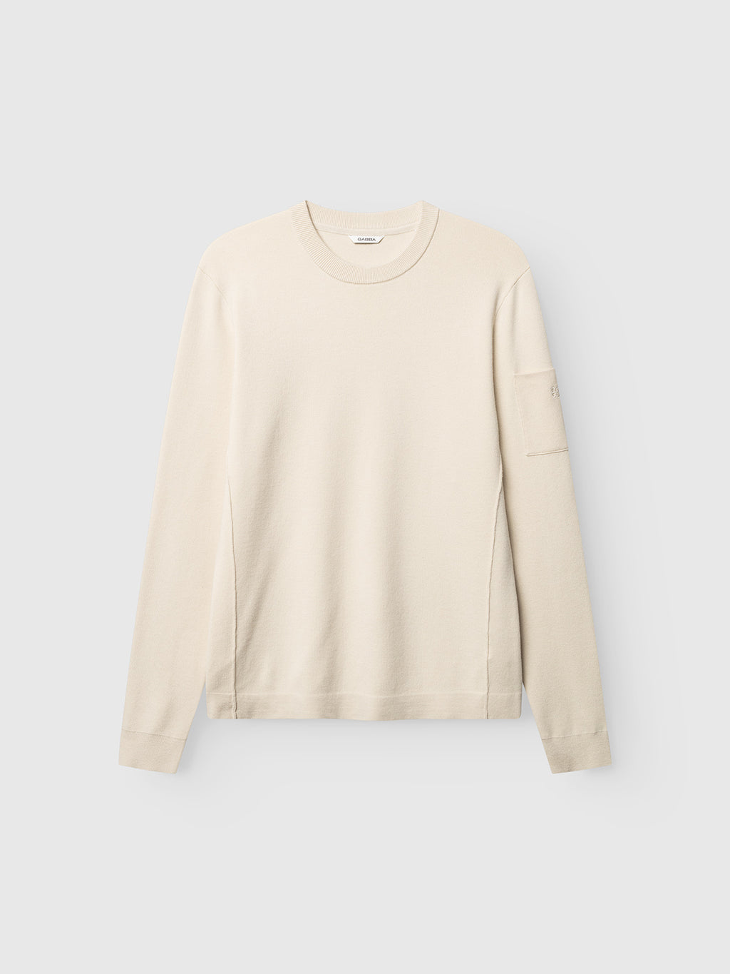 The GABadriel O-Neck Lume LS Knit sweater by Gabba in Birch is a regular fit crewneck knit featuring long sleeves and a small pocket on the left sleeve, crafted from a soft viscose blend and presented flat against a light gray background.