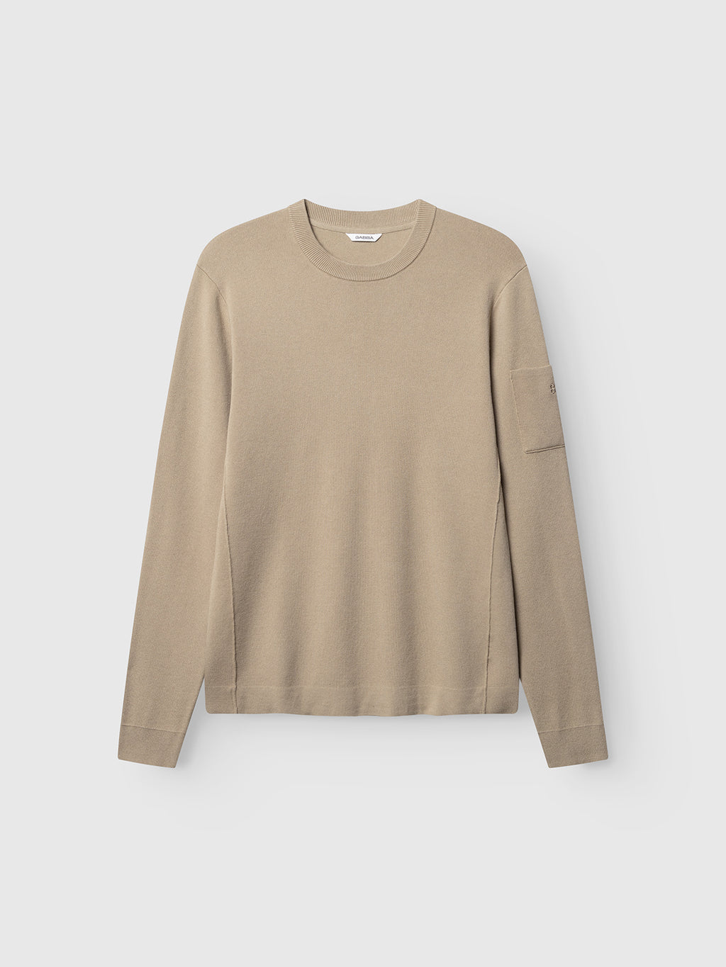 The Gabba GABadriel O-Neck Lume LS Knit in Sand Crocker is a beige regular fit sweater made from a soft viscose blend knit, featuring a classic crew neck and a subtle pocket on the left sleeve, displayed on a plain white background.