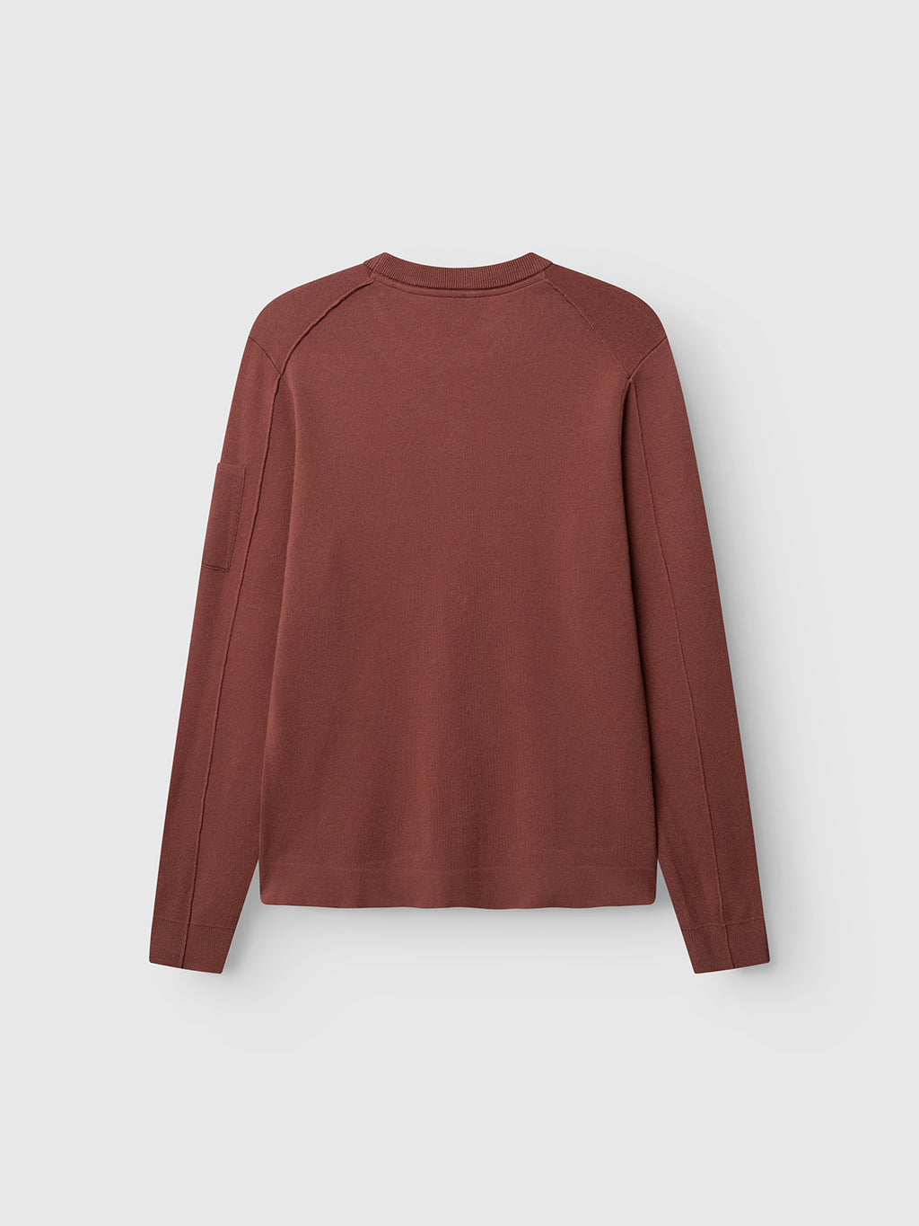 A Gabba GABadriel O-Neck Lume LS Knit in Brick Red is laid flat with the back side visible against a plain white background. Made from a soft viscose blend, this regular fit sweater features a simple, unembellished design.