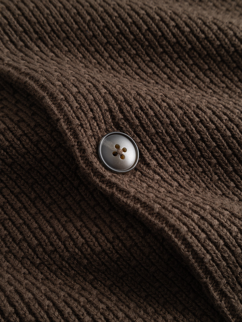 Close-up of a brown slate GABbenoit Cardi Fort LS Knit, a regular fit brown ribbed knit cardigan with a single button.