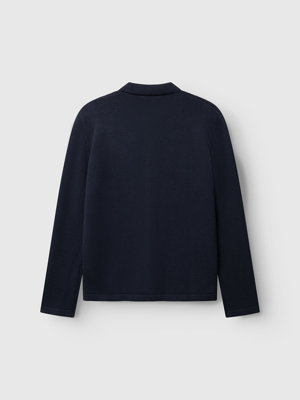 The Gabba GABbenoit Cardi Fort LS Knit in Night Sky is shown from the back, displayed against a light gray background. This regular fit sweater features a structured knit with long sleeves and a plain, dark navy design—free of visible logos, patterns, or embellishments.