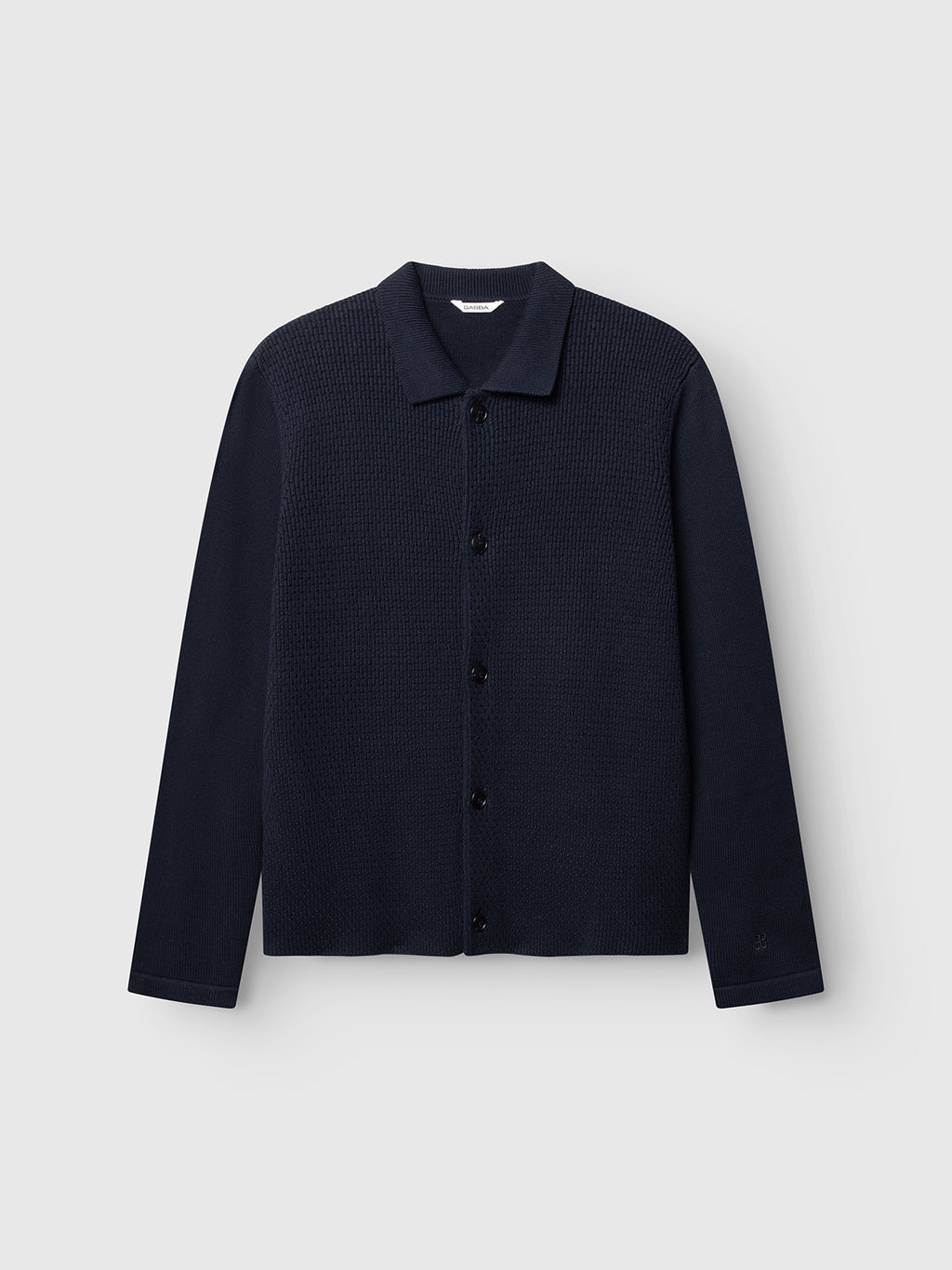 The GABbenoit Cardi Fort LS Knit - Night Sky by Gabba is a navy blue button-up cotton cardigan featuring a textured structured knit front panel, long sleeves, a classic collar, and a straight hem in a regular fit, displayed against a light gray background.