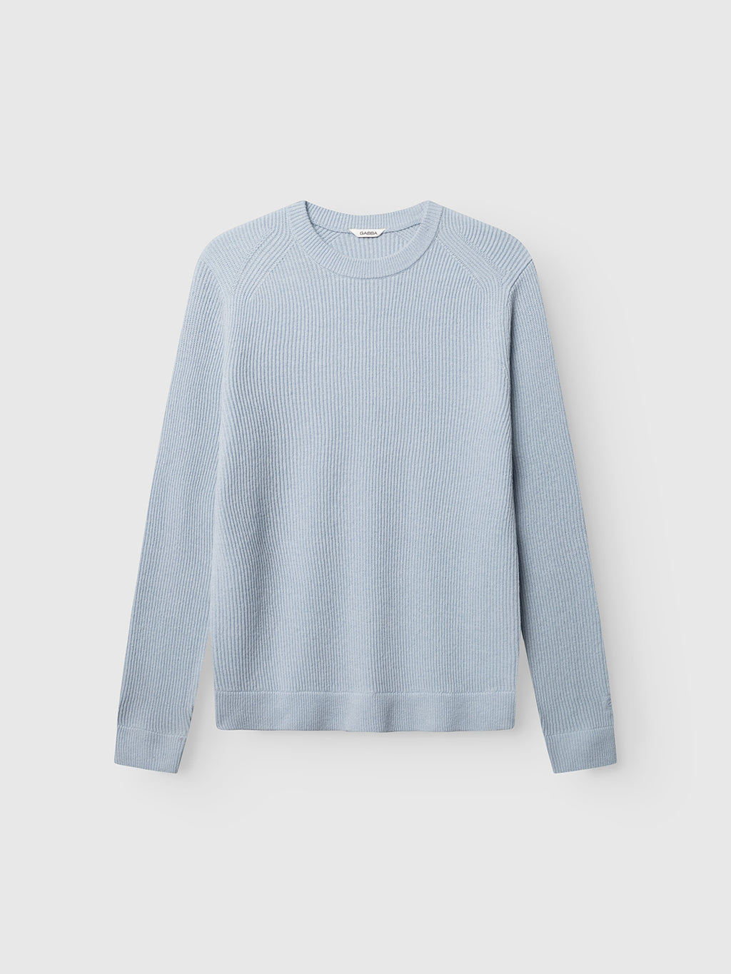 GABremy O-Neck Flash LS Knit - Dusty Blue by Gabba, a light blue 100% wool sweater with a crew neck and long sleeves, designed in a relaxed-fit knit and shown laid flat on a plain white background.