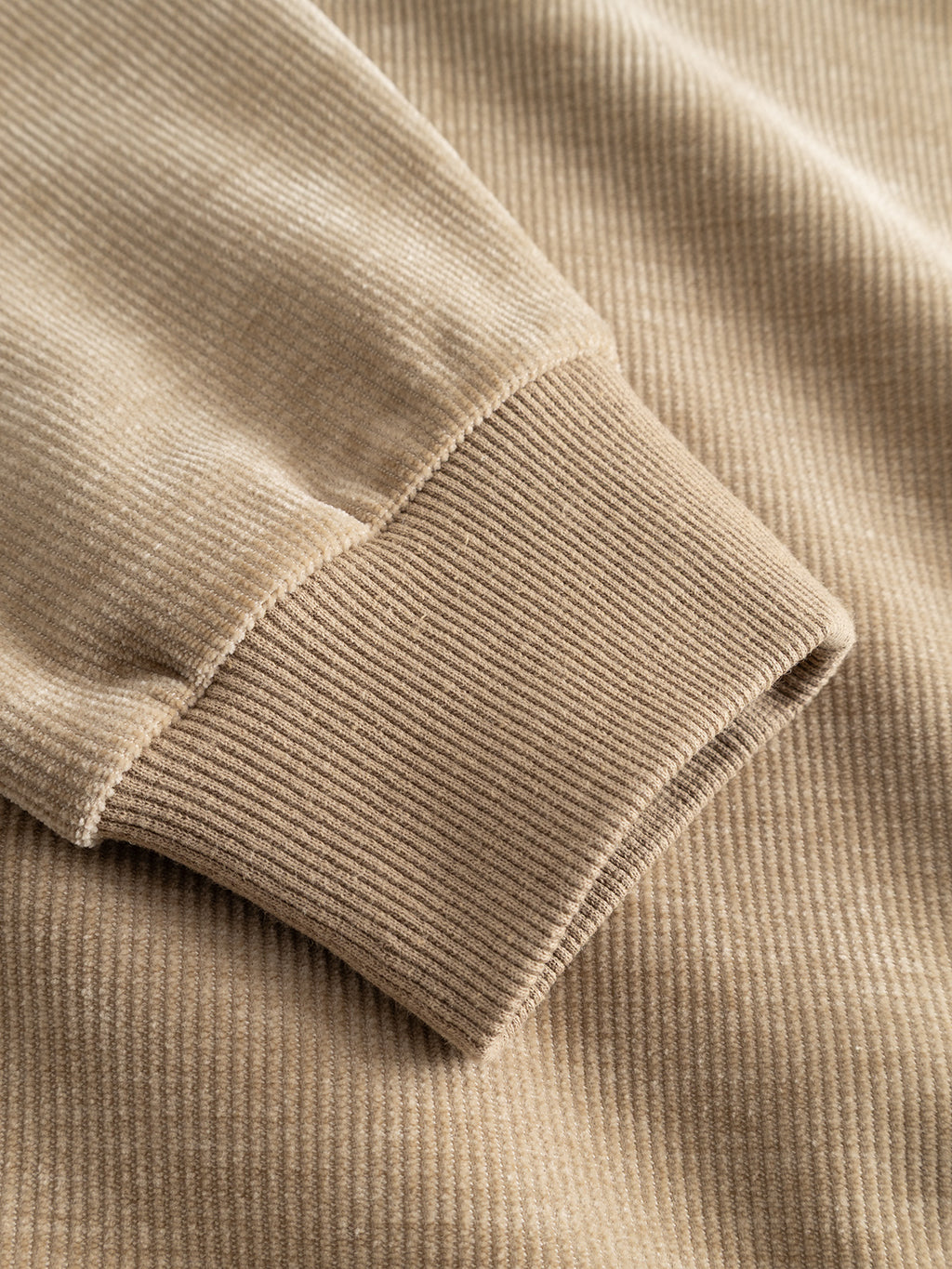 Close-up of the GABprimo Fune Hoodie LS Sweat in Sand Crocker by Gabba, highlighting the beige jersey corduroy fabric with a ribbed cuff—likely part of the sleeve—showing detailed texture and stitching.