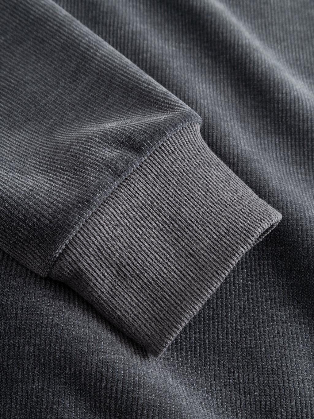 Close-up of the ribbed cuff and sleeve of the Gabba GABprimo Fune Hoodie LS Sweat in Turbulence Blue, highlighting the texture and fine vertical lines of its jersey corduroy fabric.