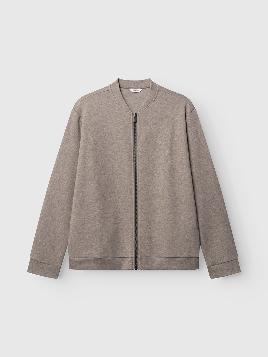 The Gabba GABnik Camp Lock Sweat - Sand Mel is a light gray zip-up jacket with a ribbed bomber collar, cuffs, and waistband, displayed against a plain white background. Crafted from mid-weight interlock fabric, this modern outerwear piece boasts a minimalist design free from visible patterns or logos.