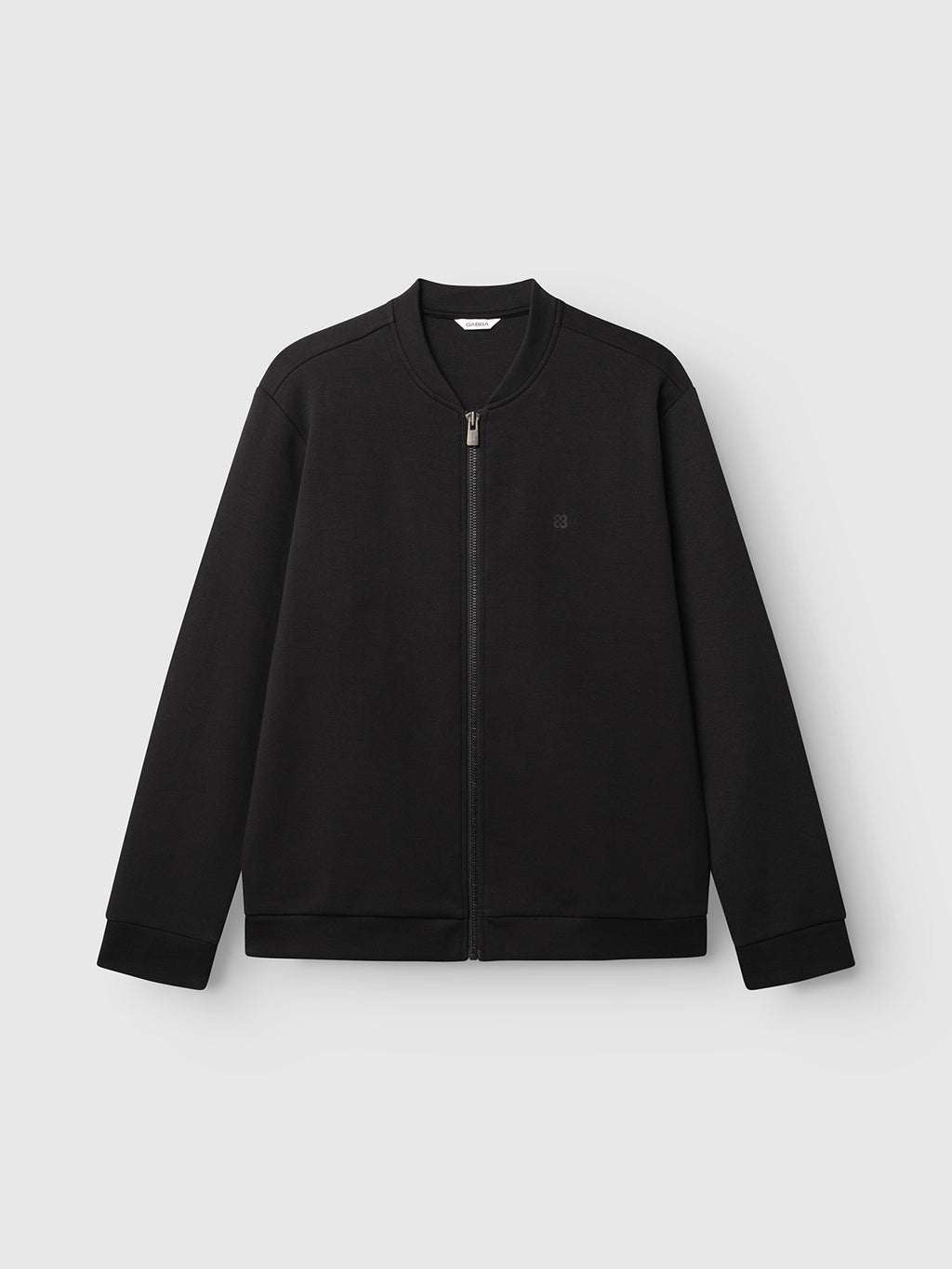 The GABnik Camp Lock Sweat - Meteorite by Gabba is a plain black zip-up jacket made from mid-weight interlock fabric, showcasing a modern outerwear silhouette with a sleek round collar and long sleeves, displayed against a light gray background.