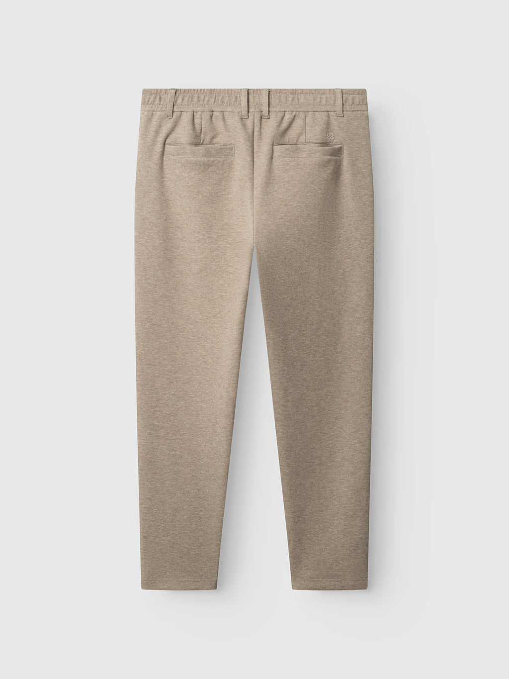 The Gabba GABmonza Cropped Tasca Lock Pant in Sand Mel is shown from the back, featuring two back welt pockets, an elastic waistband with belt loops, and relaxed straight-fit cropped legs. Crafted from a soft, mid-weight interlock fabric with a subtle textured finish.