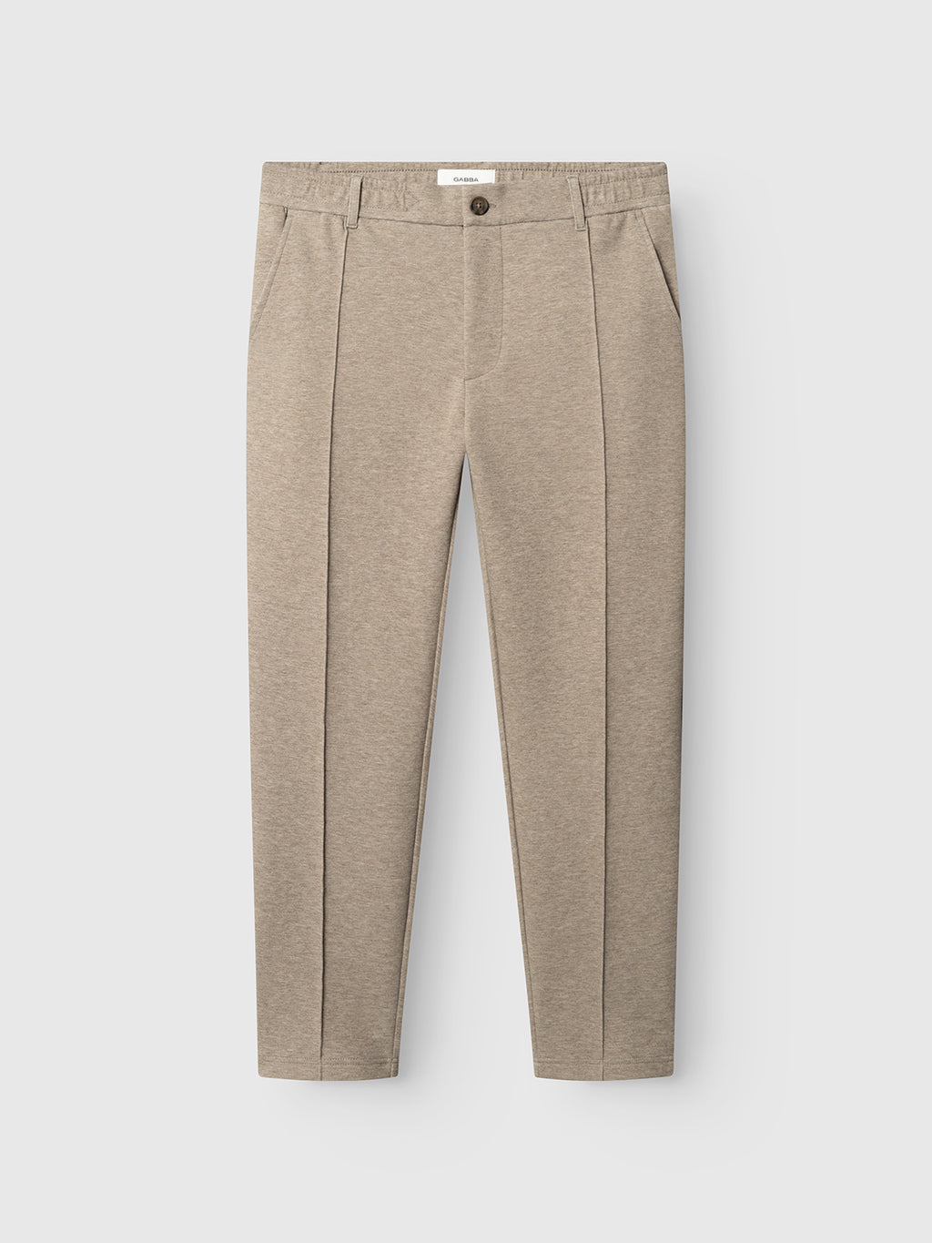 The GABmonza Cropped Tasca Lock Pant in Sand Mel by Gabba features a relaxed straight fit with front creases, side pockets, belt loops, and a single-button closure. Crafted from mid-weight interlock fabric, these trousers showcase a straight-leg silhouette and are displayed laid flat on a white background.