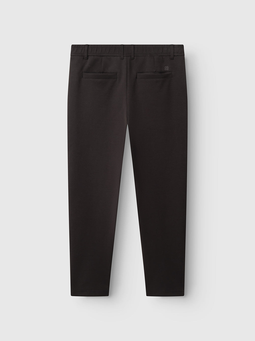Back view of the Gabba GABmonza Cropped Tasca Lock Pant in Meteorite, featuring two back pockets and a waistband, crafted from mid-weight interlock fabric in a relaxed straight fit, displayed on a plain white background.