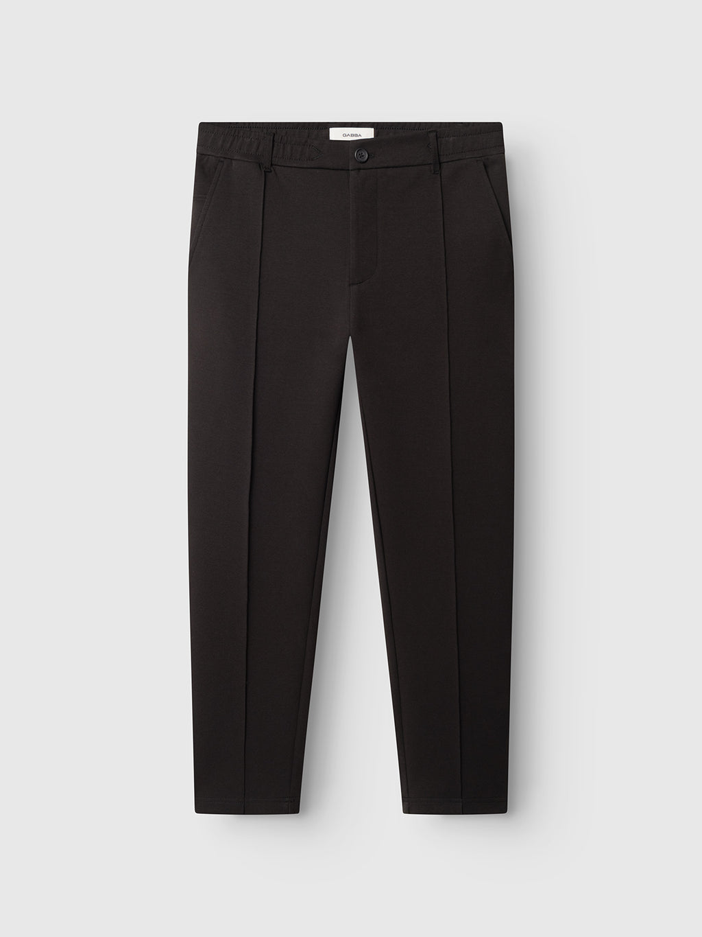 The Gabba GABmonza Cropped Tasca Lock Pant in Meteorite is a pair of black tailored trousers featuring a button closure, side pockets, and a relaxed straight fit crafted from mid-weight interlock fabric, shown against a plain white background.
