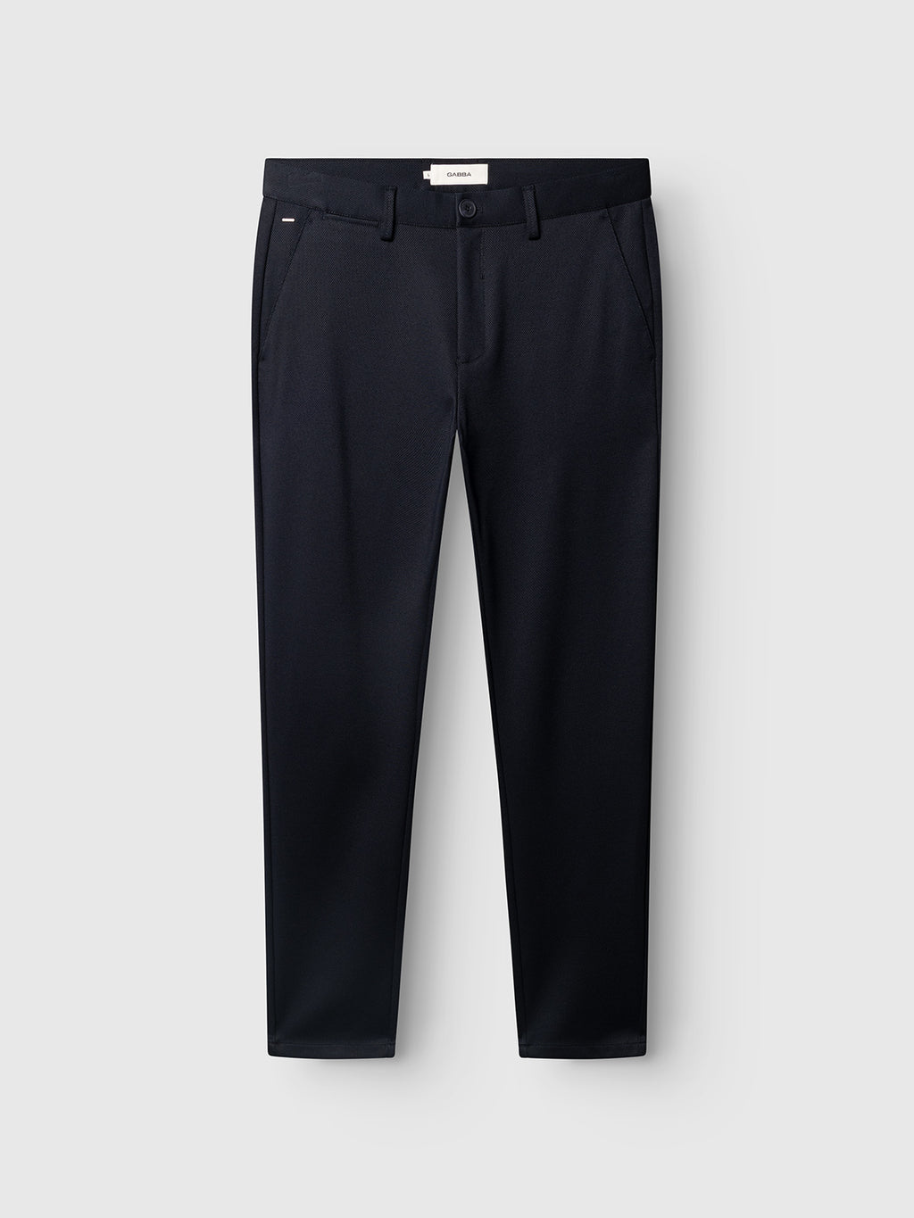 A pair of Gabba GABpaul Dotty Pant in navy, tailored with a micro-pattern weave and designed in a slim chino fit, featuring side pockets, belt loops, and a front zipper, displayed against a light gray background.