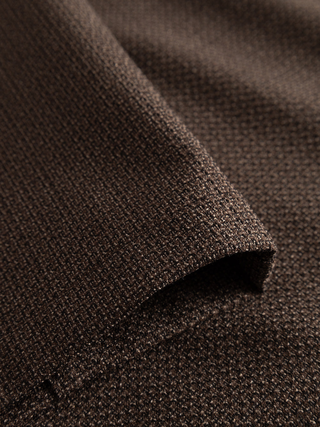 Close-up of a folded section of the Gabba GABdavid Rubin Pant in Brown Slate, highlighting the fine, tightly woven stretch dobby fabric and its soft surface detail.