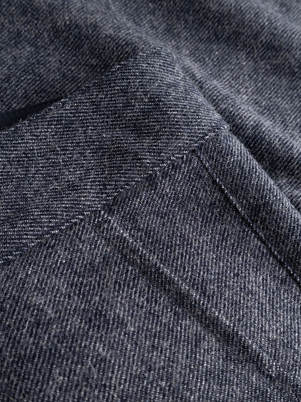 Close-up of the Gabba GABdavid Twilight Pant in Navy, highlighting the fabric’s texture and detailed stitching near the pocket. The slightly faded textile accentuates a refined weave pattern reminiscent of modern chinos, while providing a relaxed, loose tapered fit.