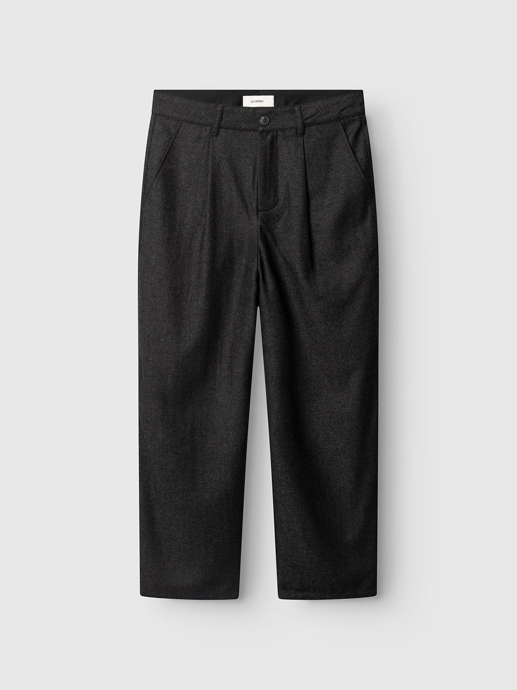 The GABdavid Twilight Pant - Dark Grey by Gabba features a loose tapered fit crafted from a dark gray wool-blend twill, designed with a button and zip closure, belt loops, two side pockets, and two back pockets. Displayed flat against a light gray background, these trousers offer a modern reinterpretation of the contemporary chino.