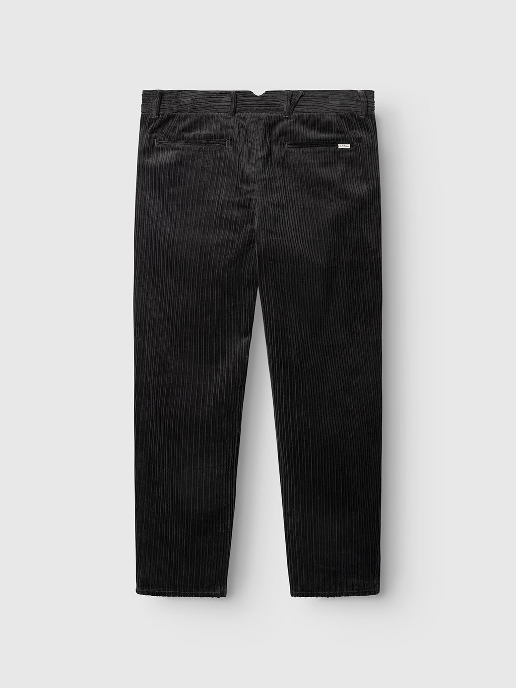 GABfirenze Cropped Riglia GOTS Pant - Dark Grey by Gabba laid flat and viewed from the back, featuring two back pockets and a small white tag on the right pocket against a light gray background. Made from organic cotton corduroy in a relaxed fit with a cropped length for effortless style.