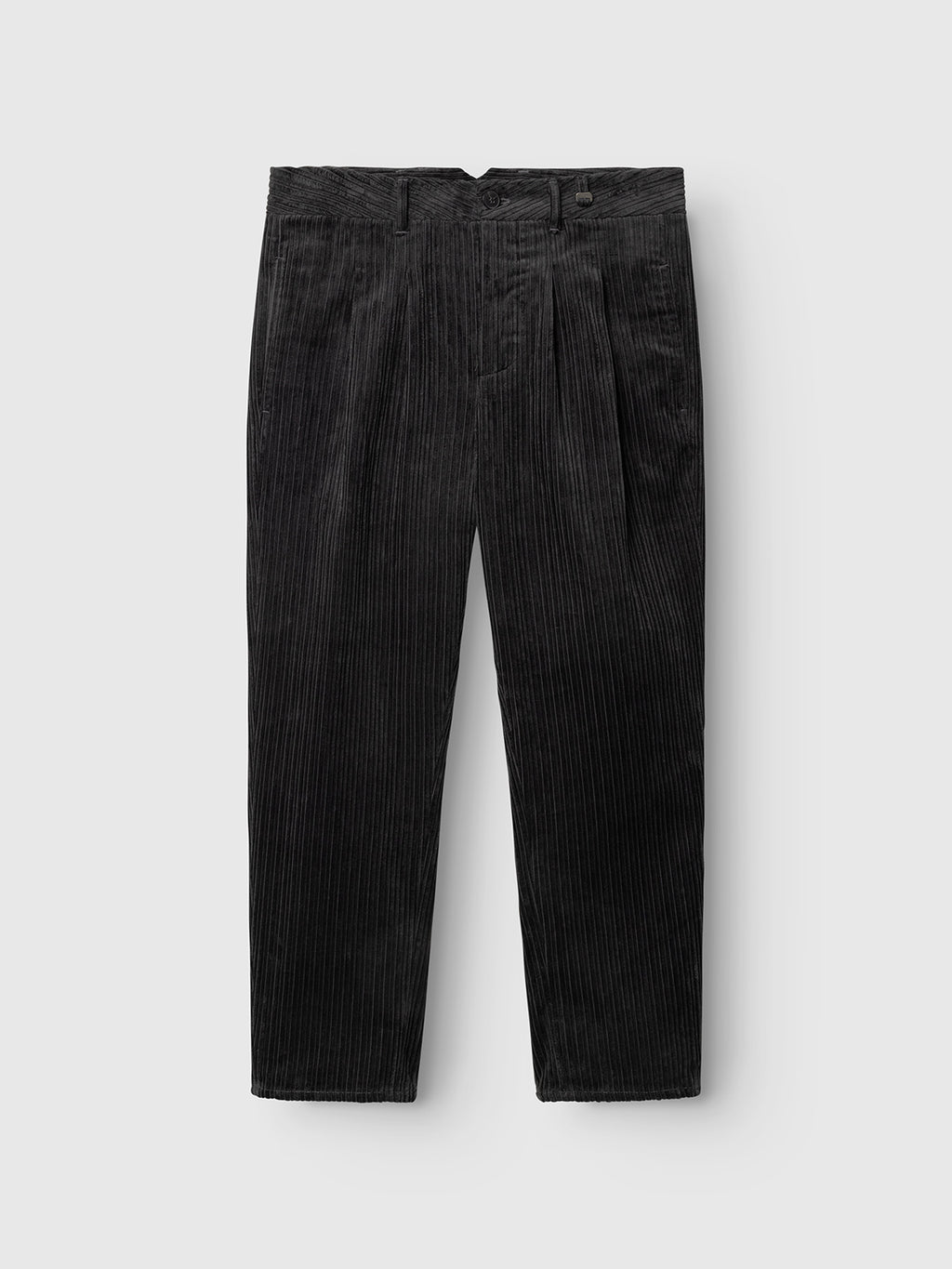 The Gabba GABfirenze Cropped Riglia GOTS Pant in dark grey, crafted from organic cotton corduroy, features belt loops, waist pleats, and straight legs in a relaxed fit, shown laid flat on a light gray background.