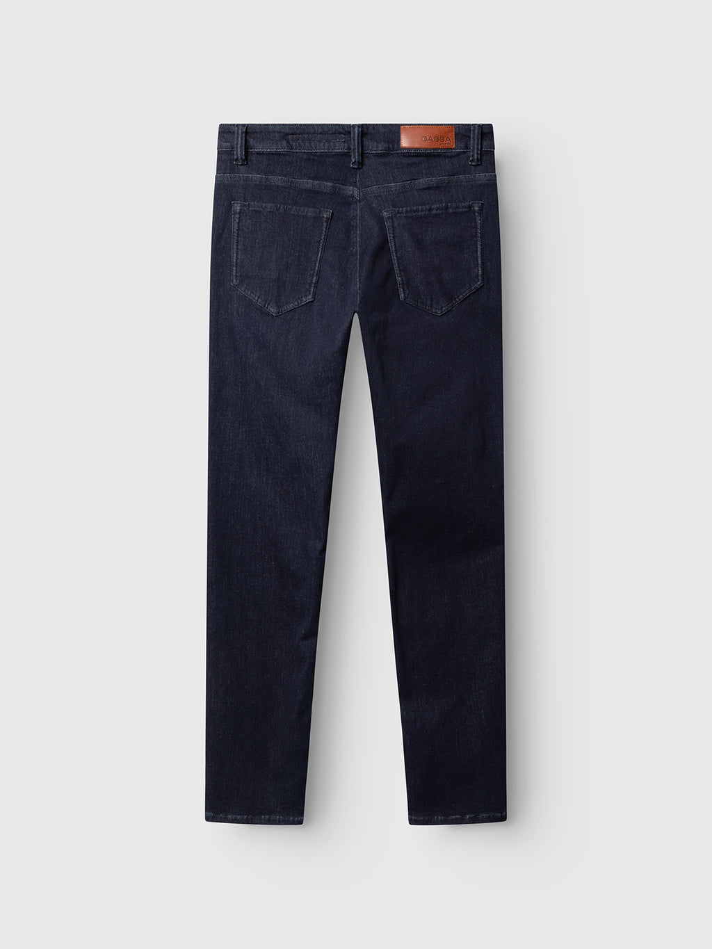The GABjones Vanew Rinse Jeans by Gabba are showcased from the back in dark blue denim, featuring a slim straight fit, two rear pockets, belt loops, and a brown leather patch on the waistband. Crafted from ISKO superstretch denim, the jeans are displayed against a light gray background.