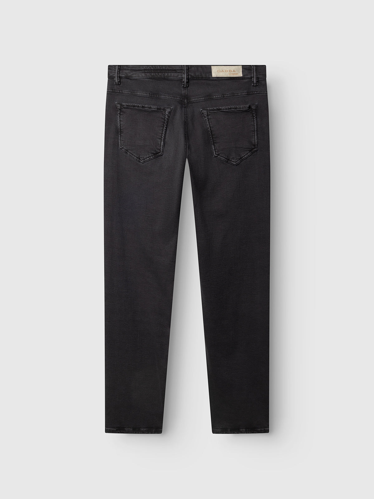 A pair of GABjones Hesky Jeans in black denim by Gabba, displayed flat from the back, featuring two back pockets and a light-colored rectangular brand patch on the waistband.