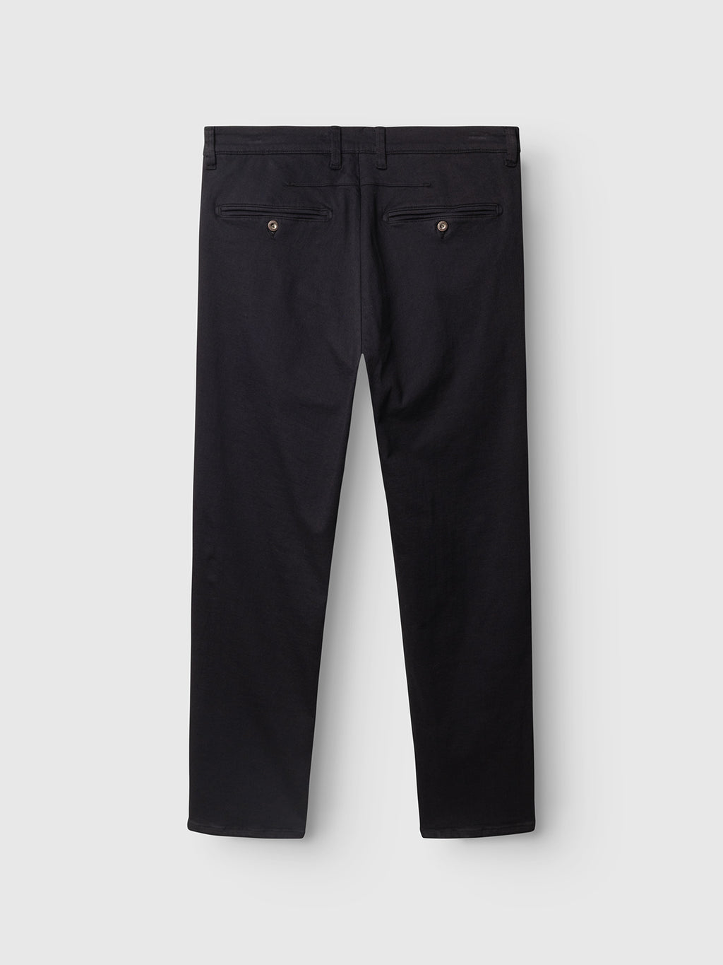 The GABpaul Hesky Pant by Gabba is shown laid flat in navy, highlighting its slim chino fit with two back pockets—each featuring a button closure—and belt loops at the waistband, crafted from high-stretch garment-dyed fabric against a light background.