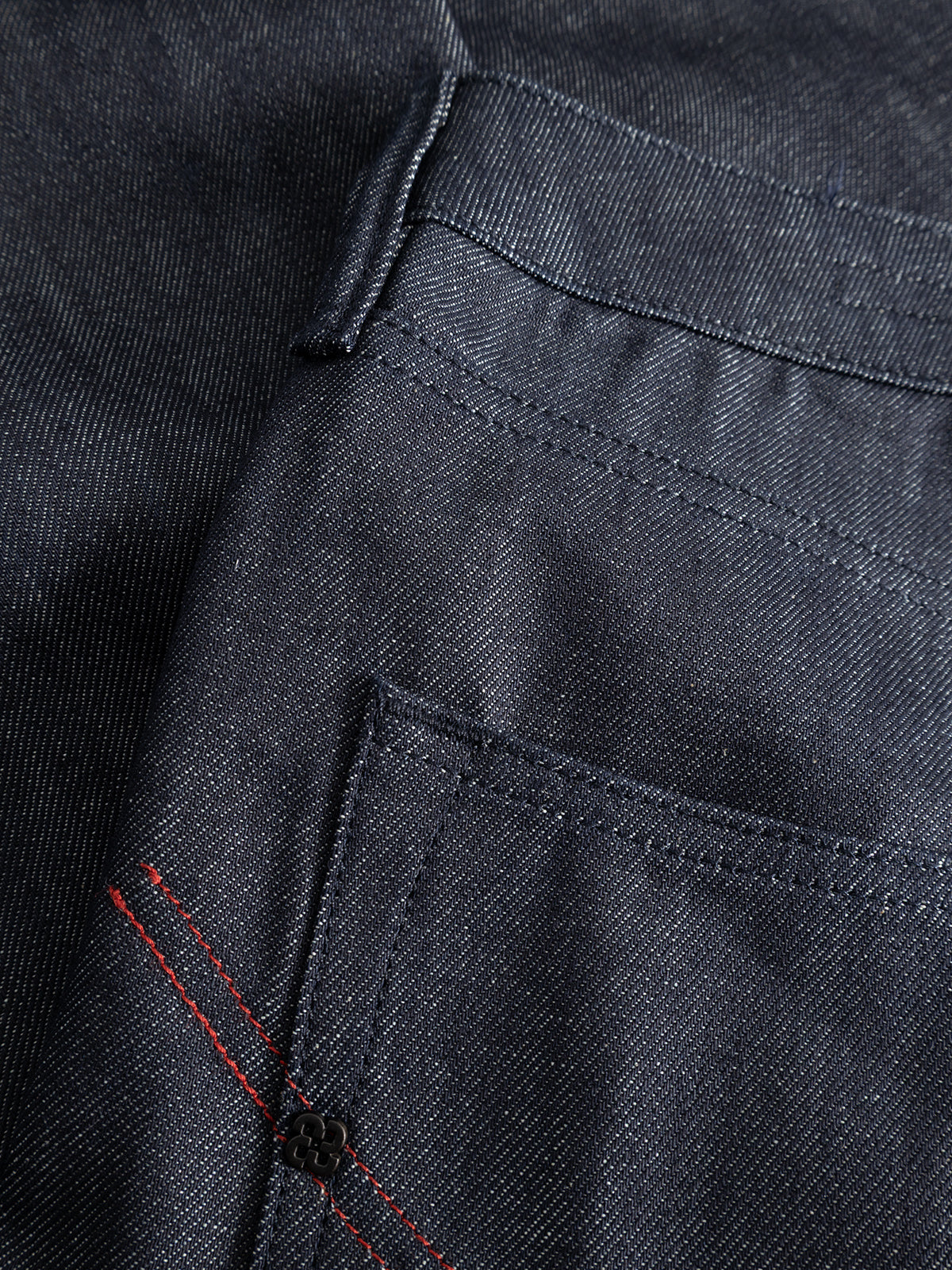 Close-up of GABcarl Anark Stone Raw Jeans in dark blue denim by Gabba, crafted from premium ISKO denim, highlighting the front pocket details, stitching, and a red accent near the edge.