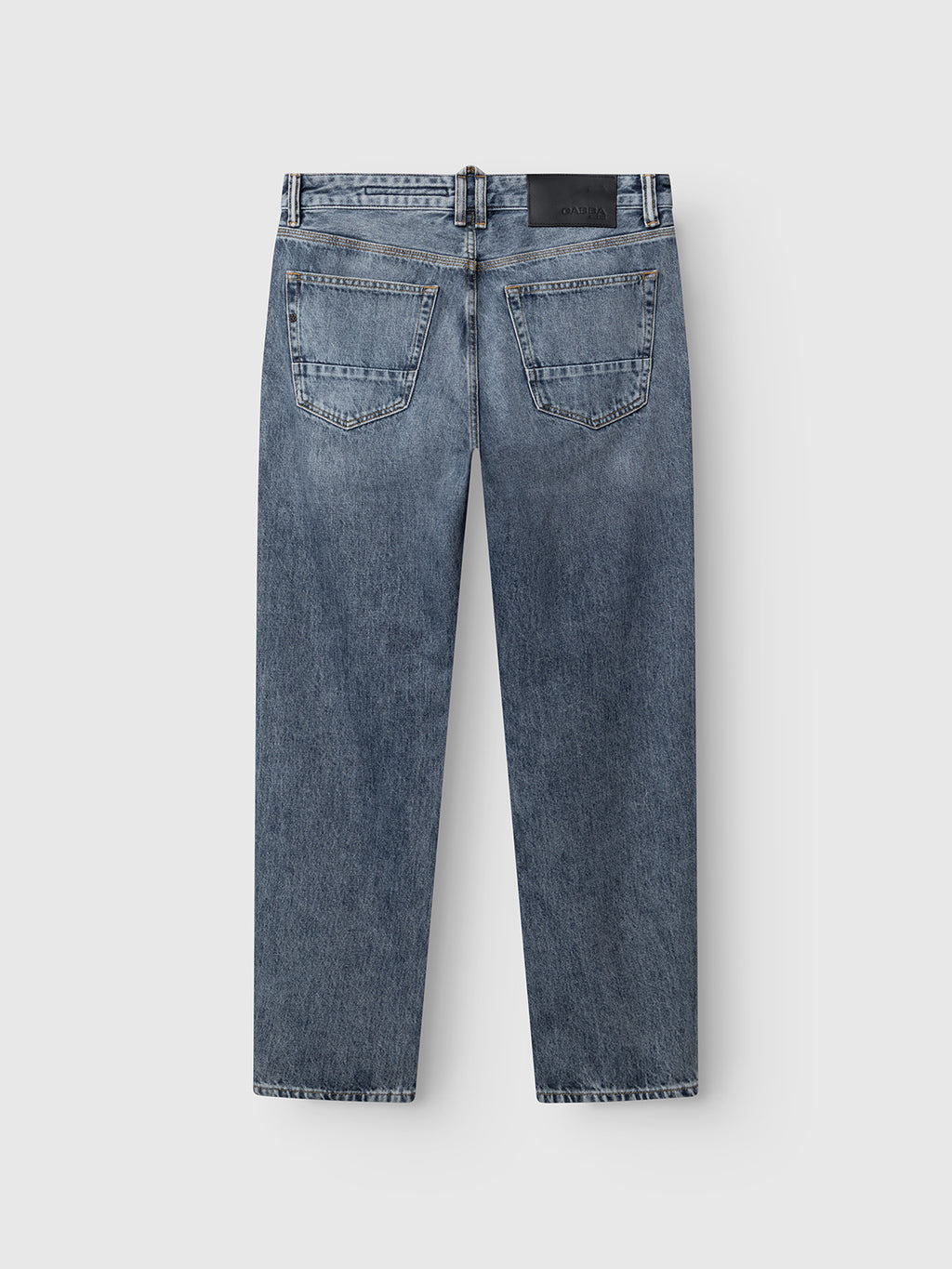 Back view of the Gabba GABcarl Stone RS2103 Jeans in mid blue denim, crafted from premium ISKO fabric. These loose tapered fit jeans feature two back pockets, a straight leg cut, and a black rectangular patch on the waistband. The jeans are displayed laid flat on a white background.