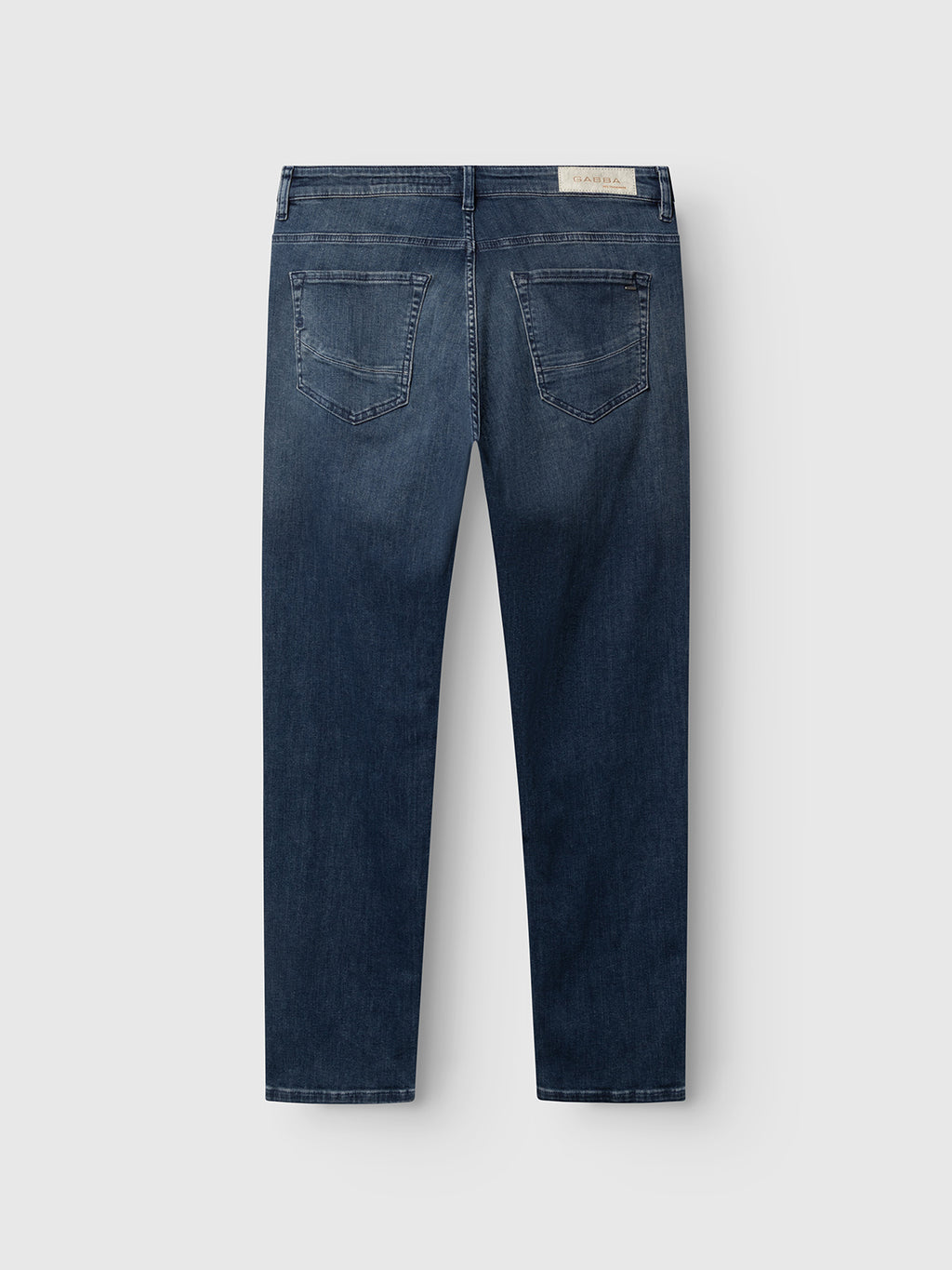 The GABmarc Nham RS2113 Jeans by Gabba are regular fit dark blue denim jeans shown from the back, featuring two back pockets, subtle fading, and a white Gabba brand label on the waistband. Crafted from ISKO stretch denim, they offer enhanced performance comfort and ease of movement.