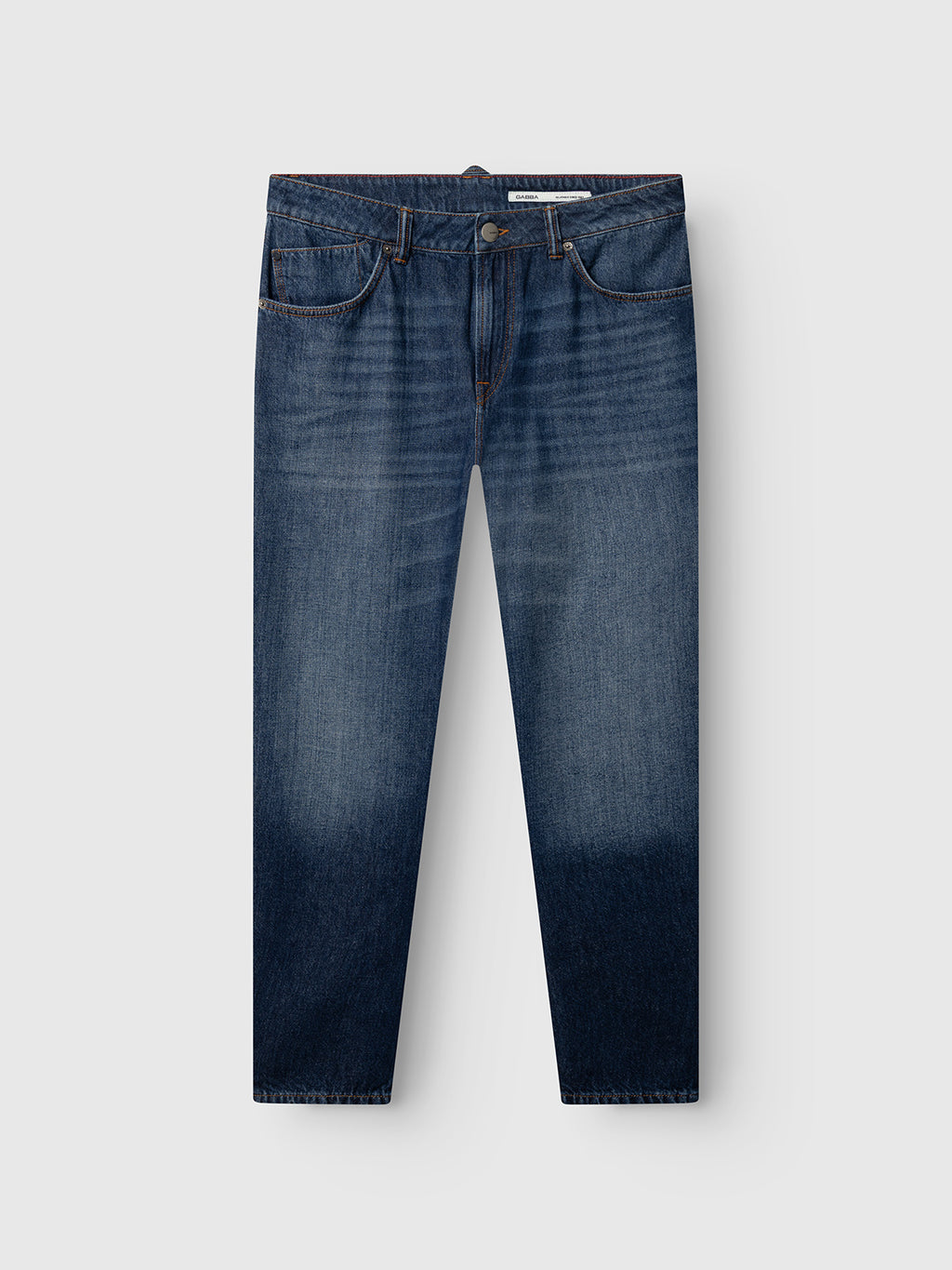 The GABcarl Tona RS2101 Jeans by Gabba are a pair of mid blue denim, loose tapered fit jeans crafted from organic cotton, featuring a faded gradient effect at the bottom, classic five-pocket styling, and a button and zipper closure. They are displayed against a light gray background.