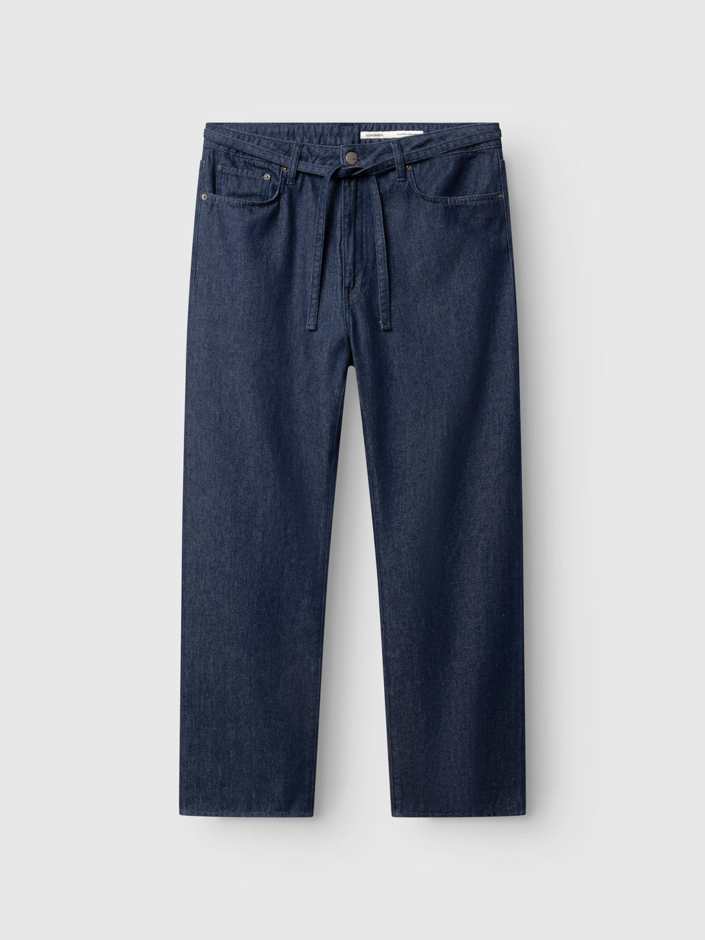 The Gabba GABnoah Tona Rinse Jeans in dark blue denim feature a straight-leg silhouette crafted from rigid indigo denim, complete with a tie belt at the waist, button and zip closure, front and back pockets, and are displayed against a plain light background.