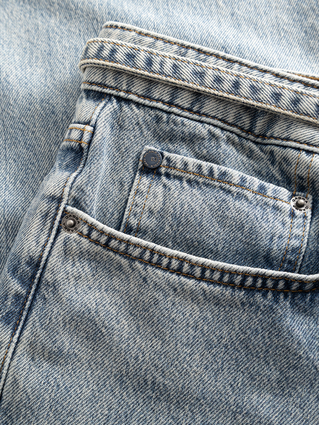 A close-up of the small front pocket and waistband on the Gabba GABnoah Tona RS2100 Jeans in mid blue denim, crafted from organic cotton, showing the fabric texture and stitching details.