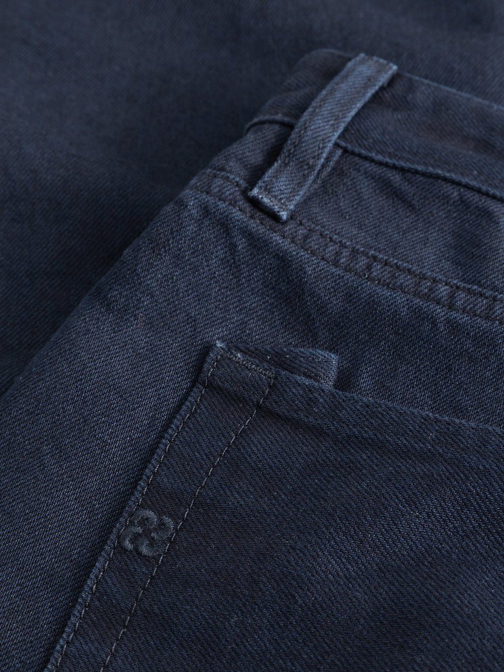Close-up view of the front pocket area of the Gabba GABsenna Denia Rinse Jeans in dark blue denim, highlighting the stitching, belt loop, and fabric texture.